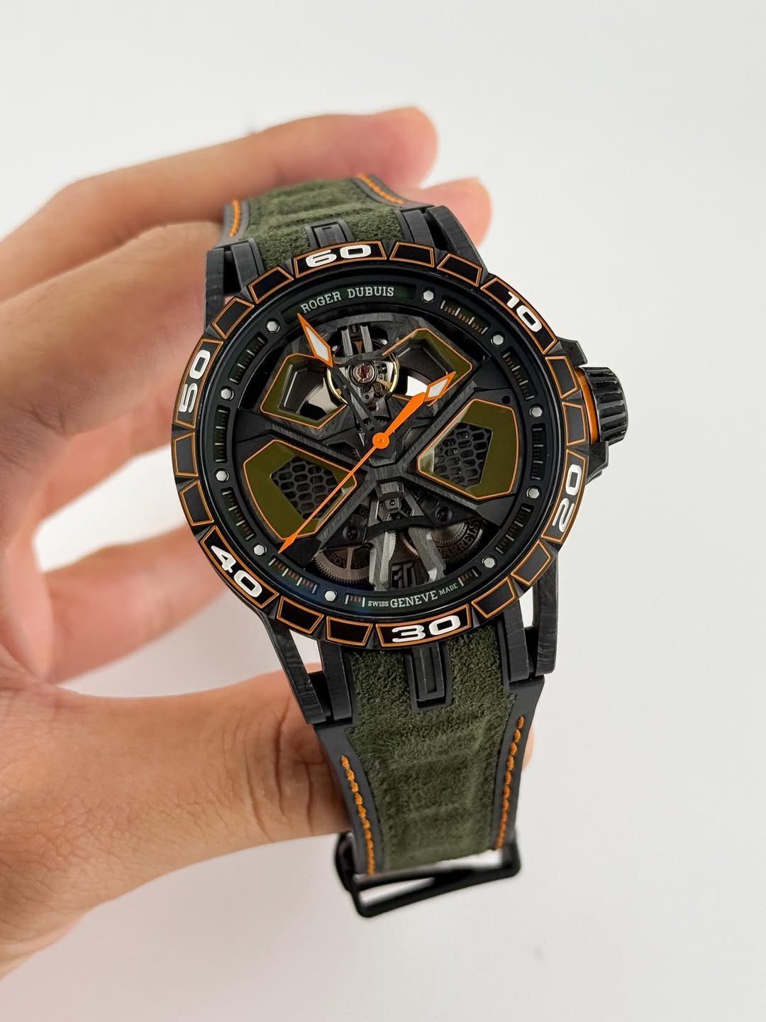 May be an image of digital watch and text that says 'ROGER DUBUIS UIS WI期 GF GENEVE rE'