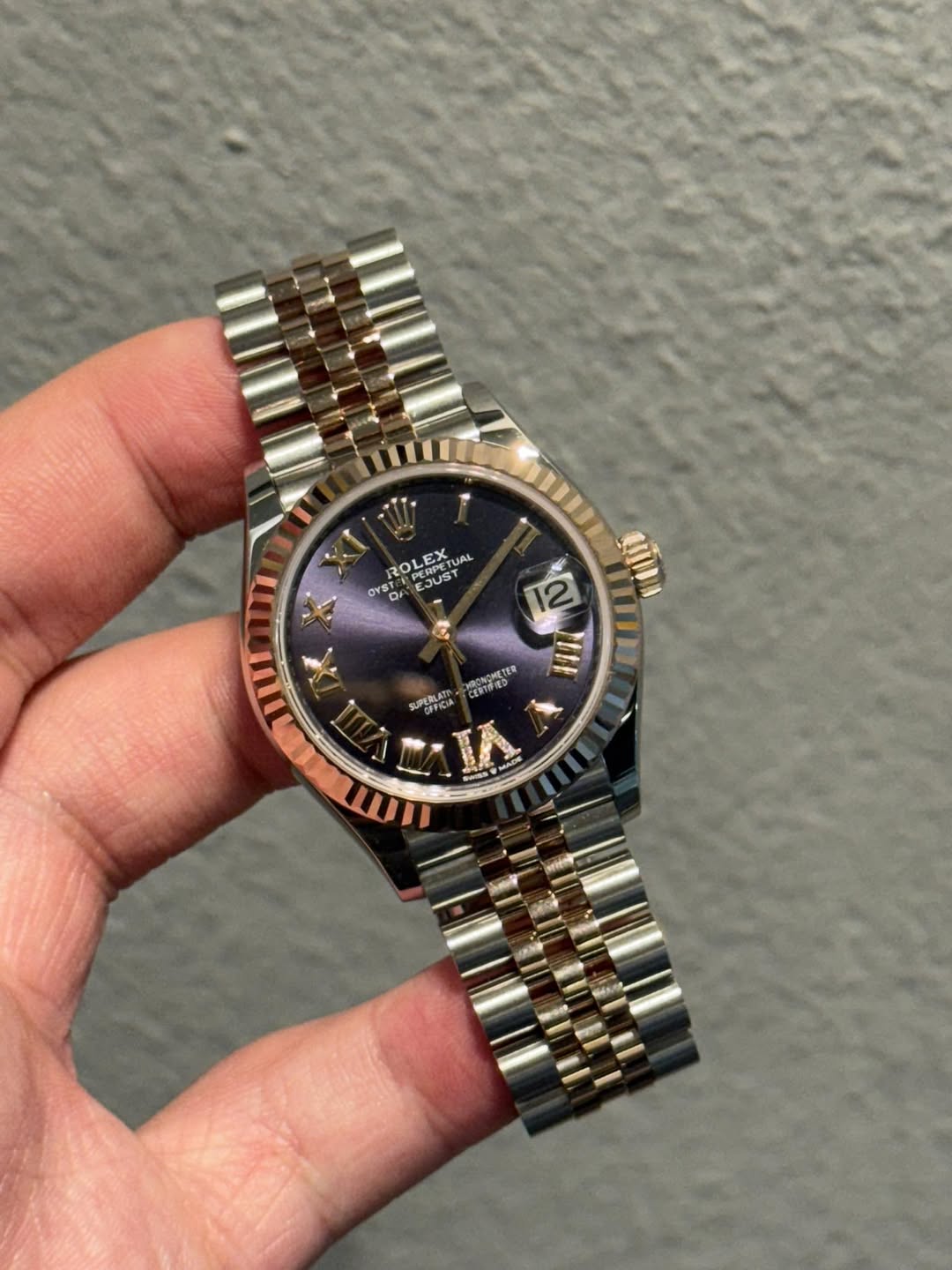 May be an image of wrist watch and text