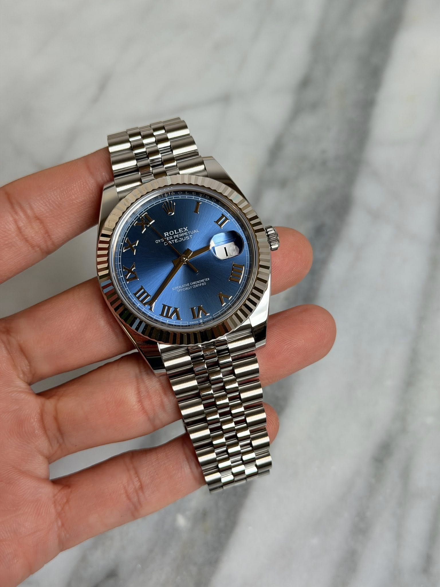 May be an image of wrist watch and text that says 'ROLEX PERPETUA EX ROL III للا AII VIII'