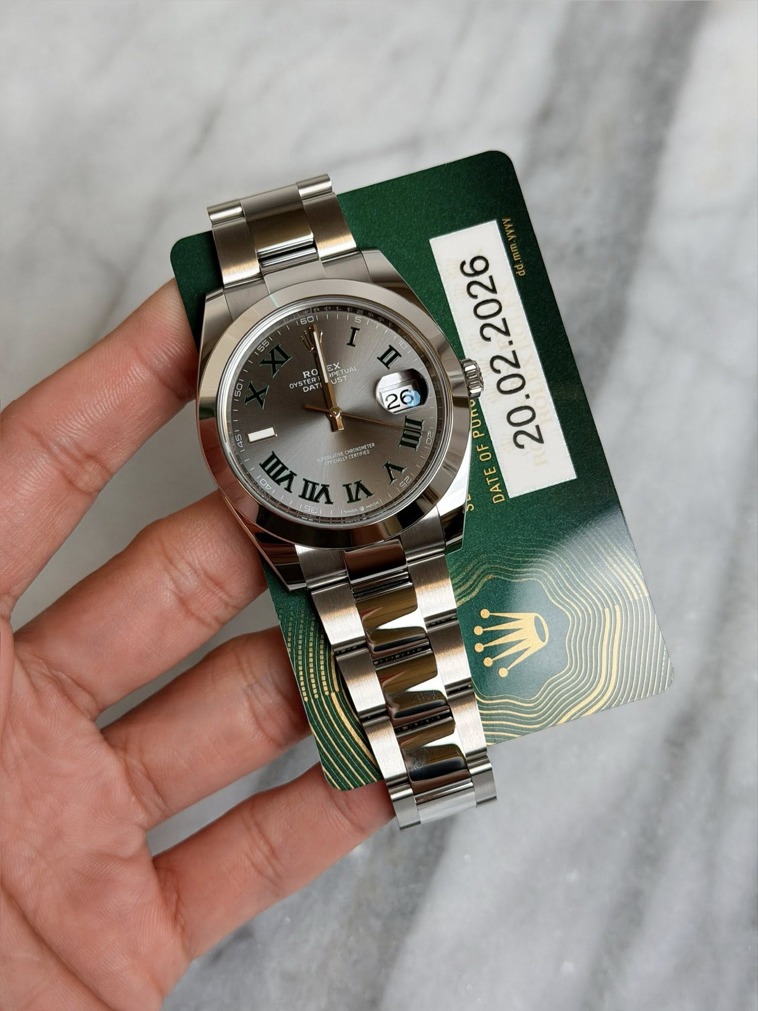 May be an image of wrist watch and text