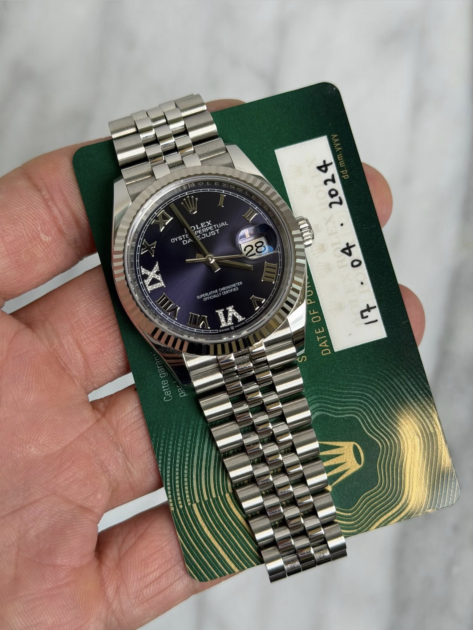 May be an image of wrist watch and text