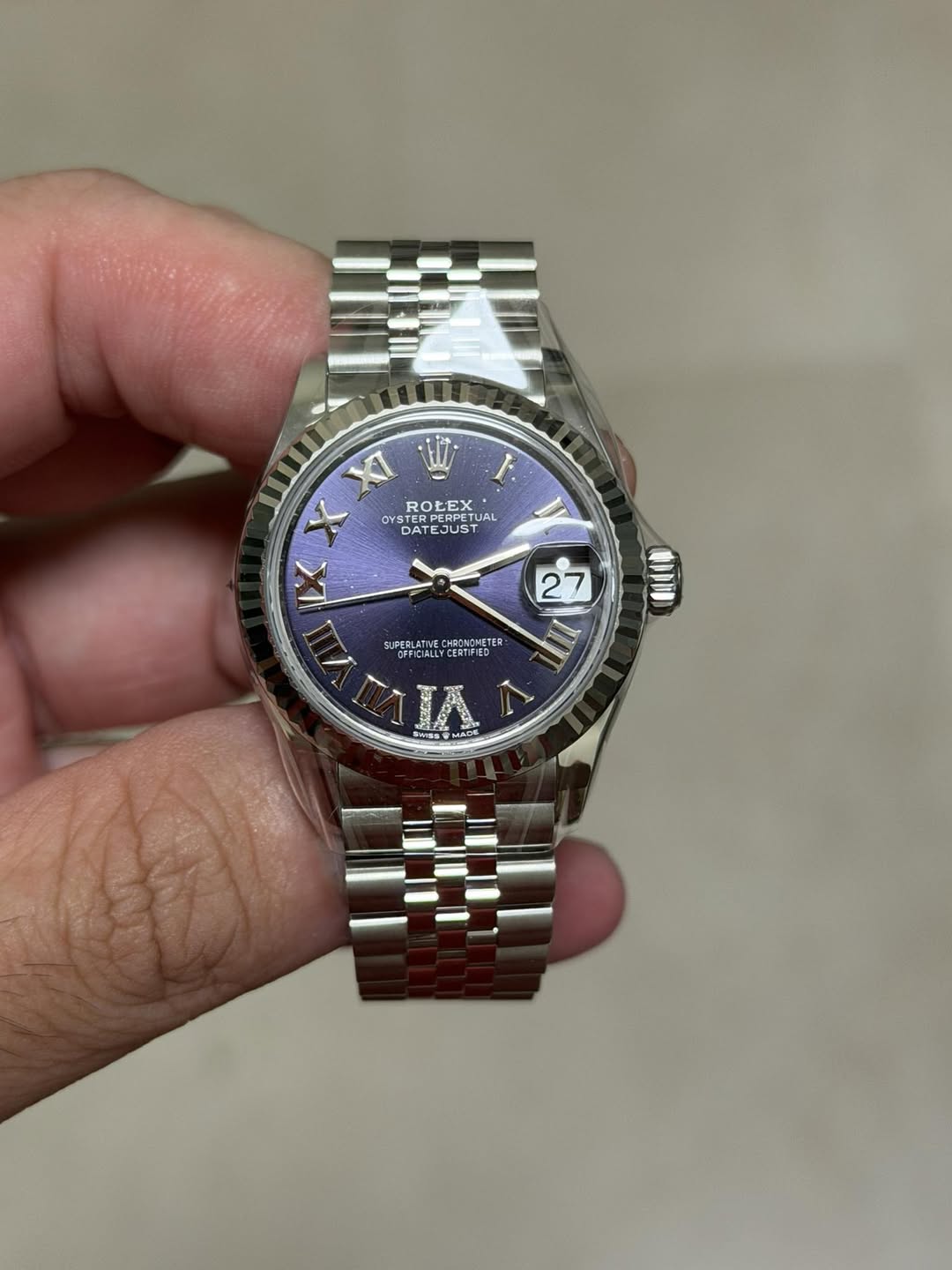 May be an image of wrist watch and text