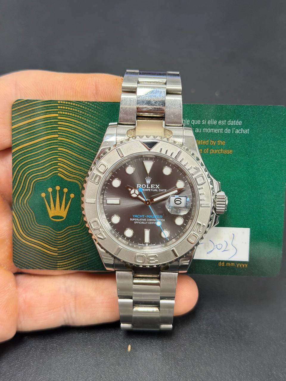 May be an image of wrist watch and text that says 'ከ/ይ que blequesielleestdatée i elle est datée aumomentdel'achat au moment de 'achat lated the of purchase 50 ٥ ROLEX OLEX EX ROL…