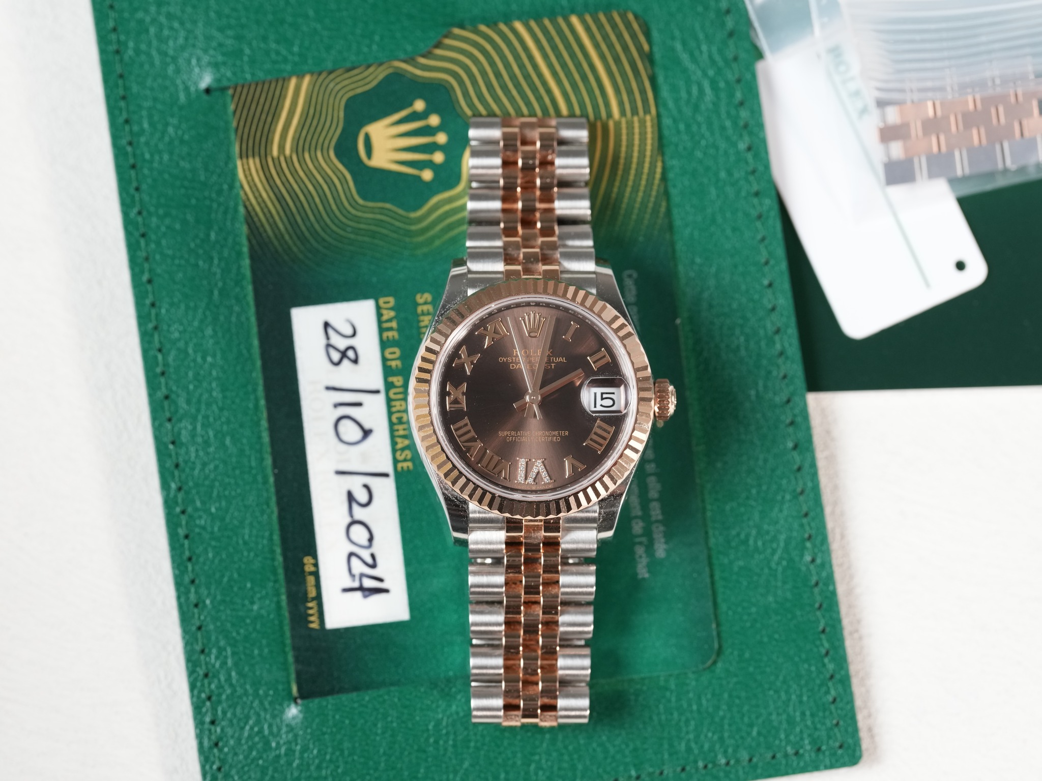 May be an image of wrist watch and text that says '15 28 DATE SER OF 10 PURCHASE රල් mm.jyyy 28/10/ S'