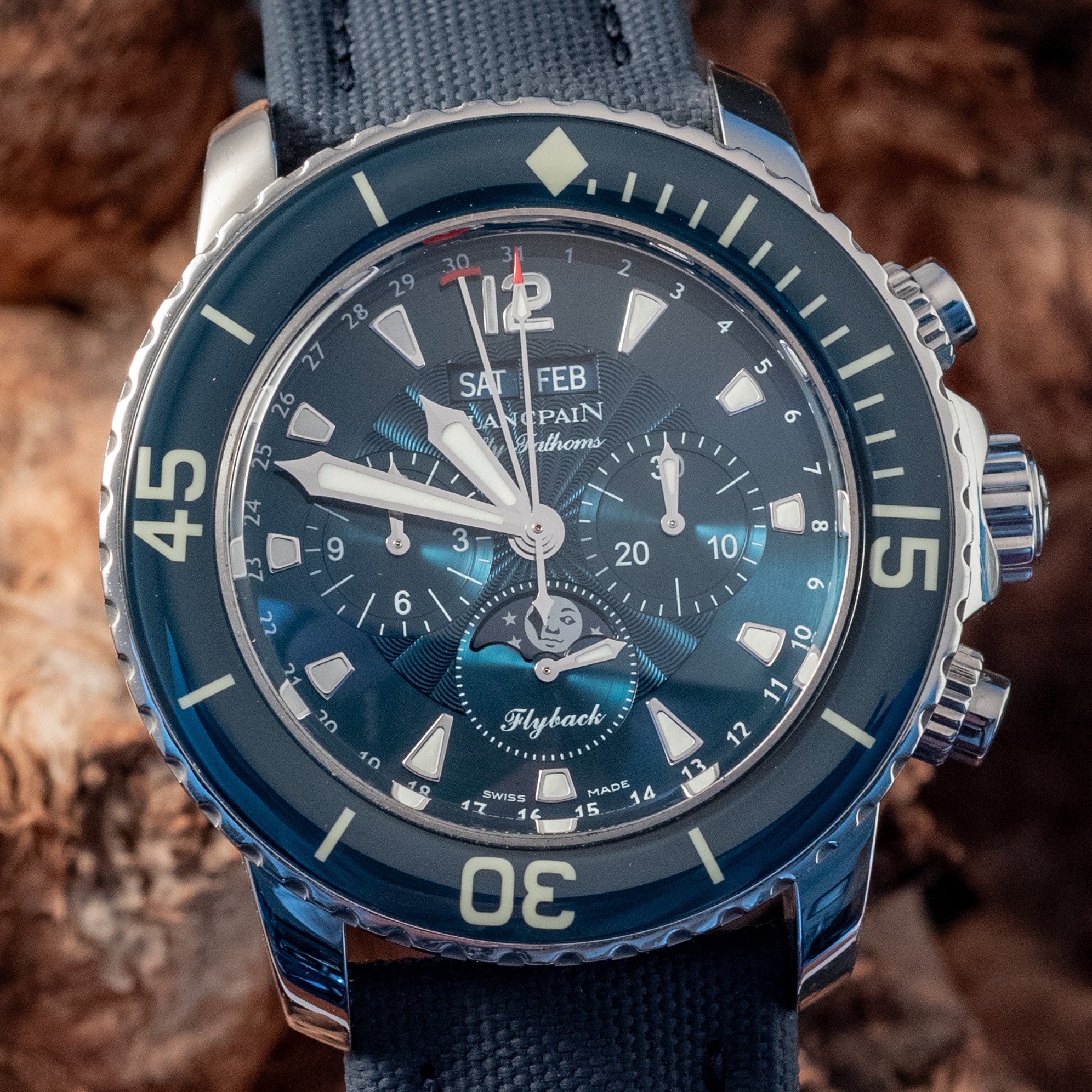 May be an image of wrist watch and text that says ' eL SAT FEB BA PAIN thoms HK LAD د cO 6 15 oz SYSESAUE yyHHy Flyback SWTSS MADE 4 17 5 σε 0'