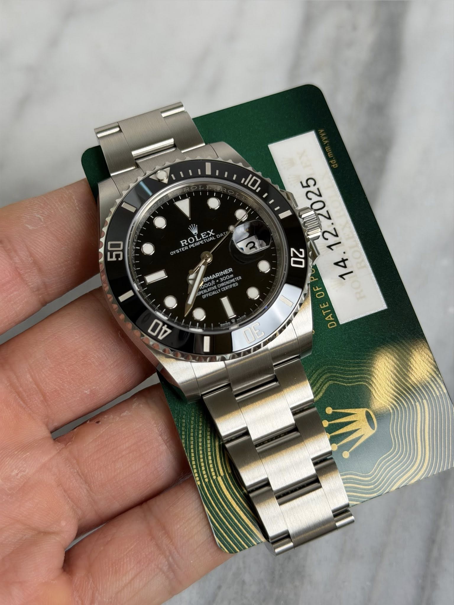 May be an image of wrist watch and text that says '50 ROLEX PERPETUAL ROL BMARINER *300T 10, OF TE DATE O D0 UE'
