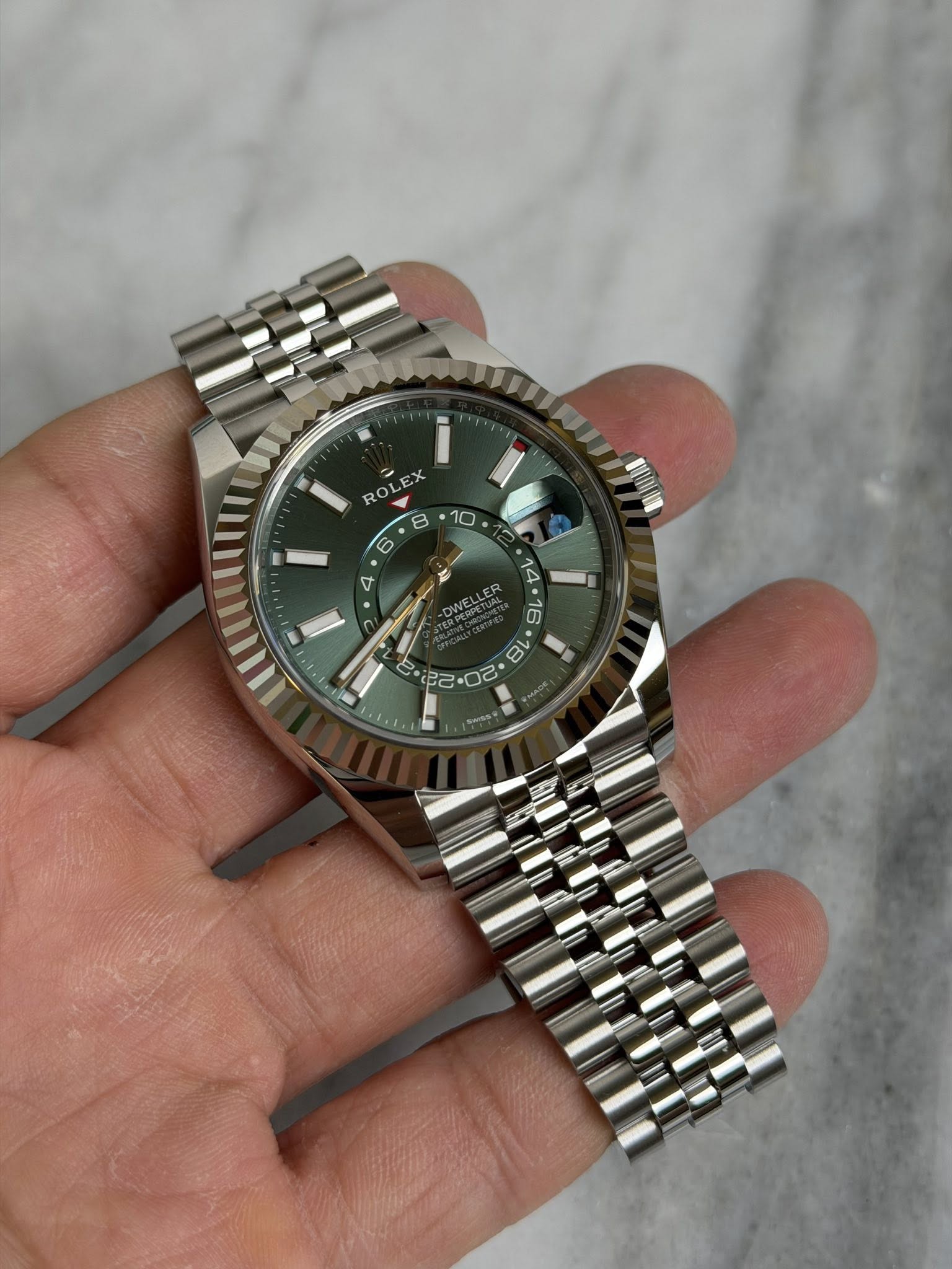 May be an image of wrist watch and text