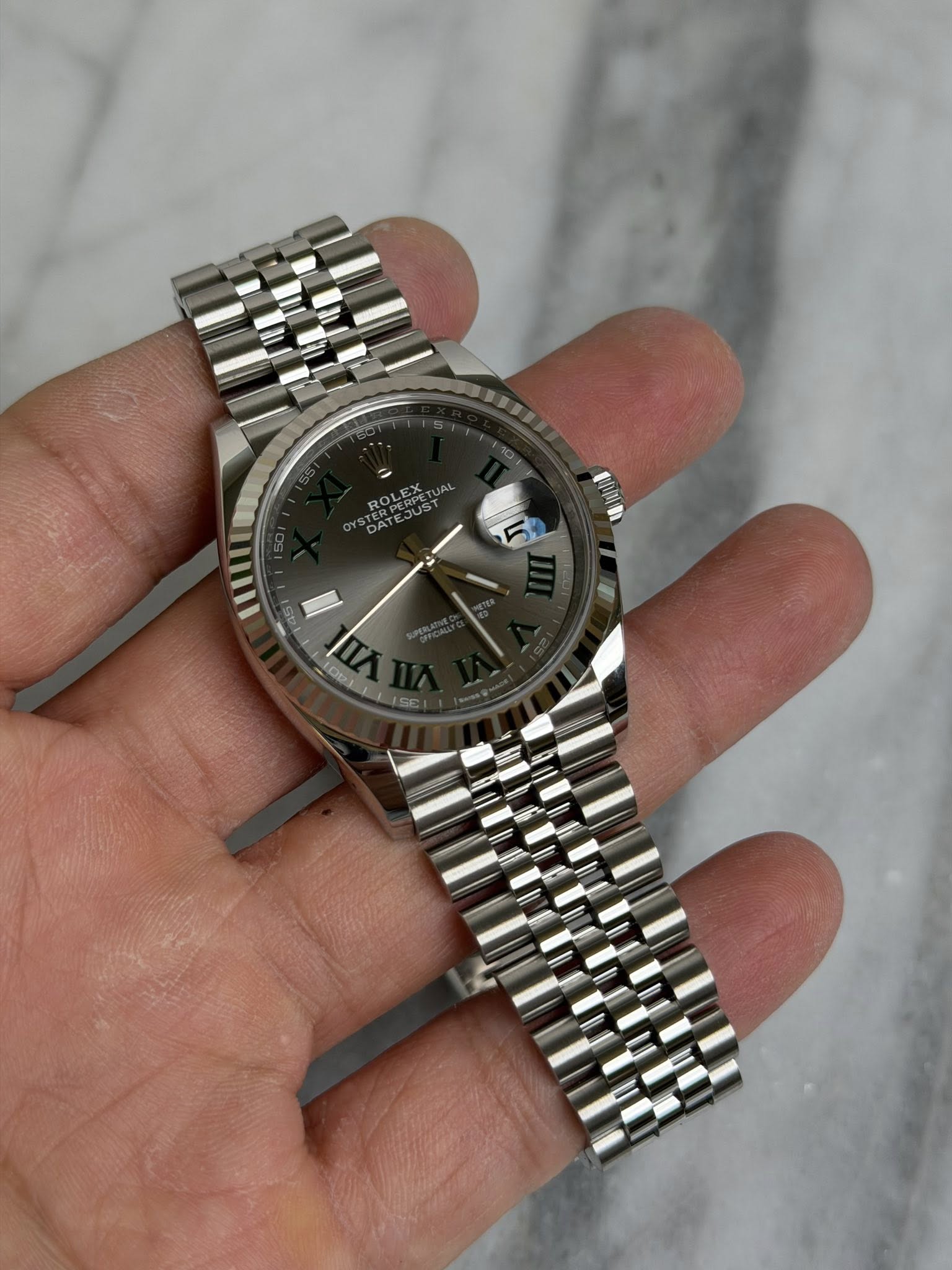 May be an image of wrist watch and text