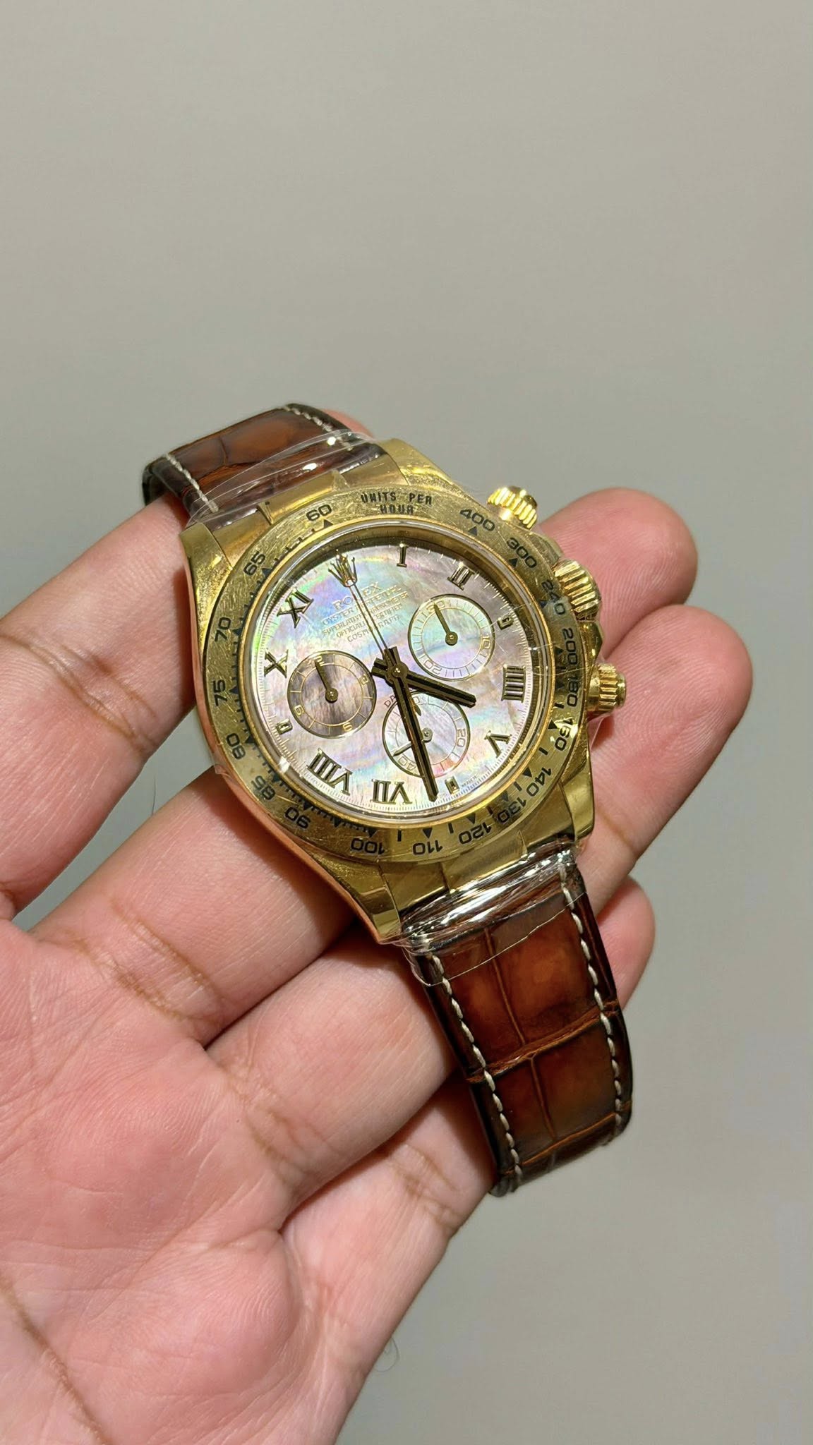 May be an image of wrist watch and text