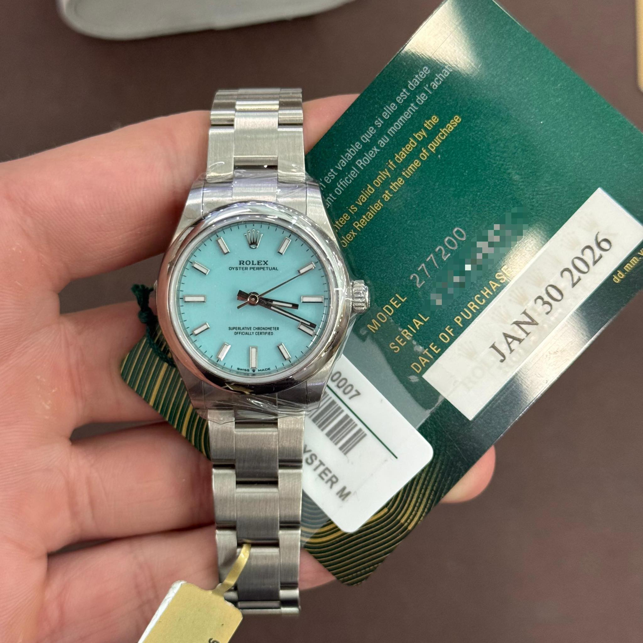 May be an image of wrist watch and text that says '. ROLEX STPRTIAN EPETIM U datee achat stelle oment td alable Role datedb the purchase est officiel ficie Ivalid the thet et time…