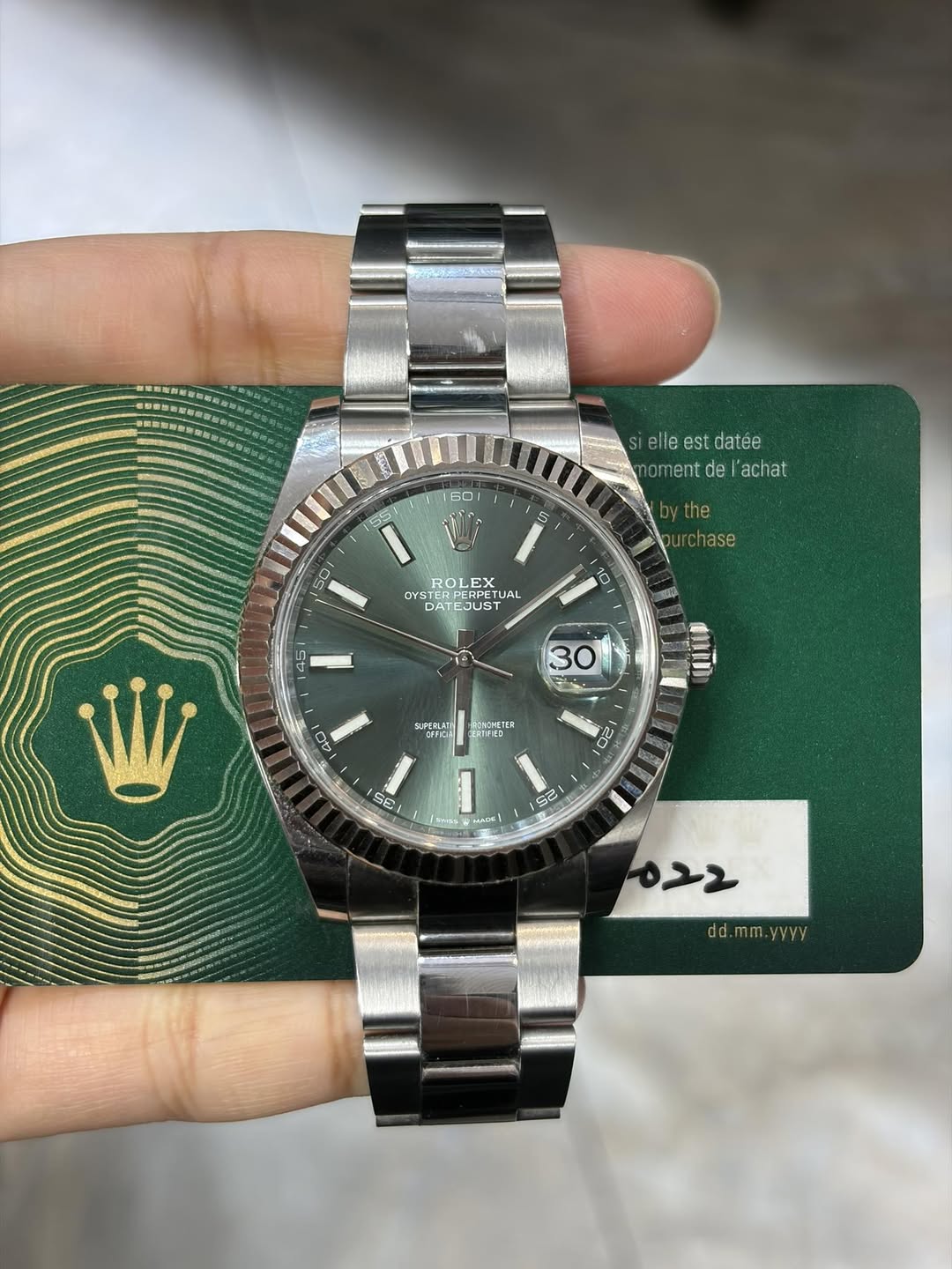 May be an image of wrist watch and text