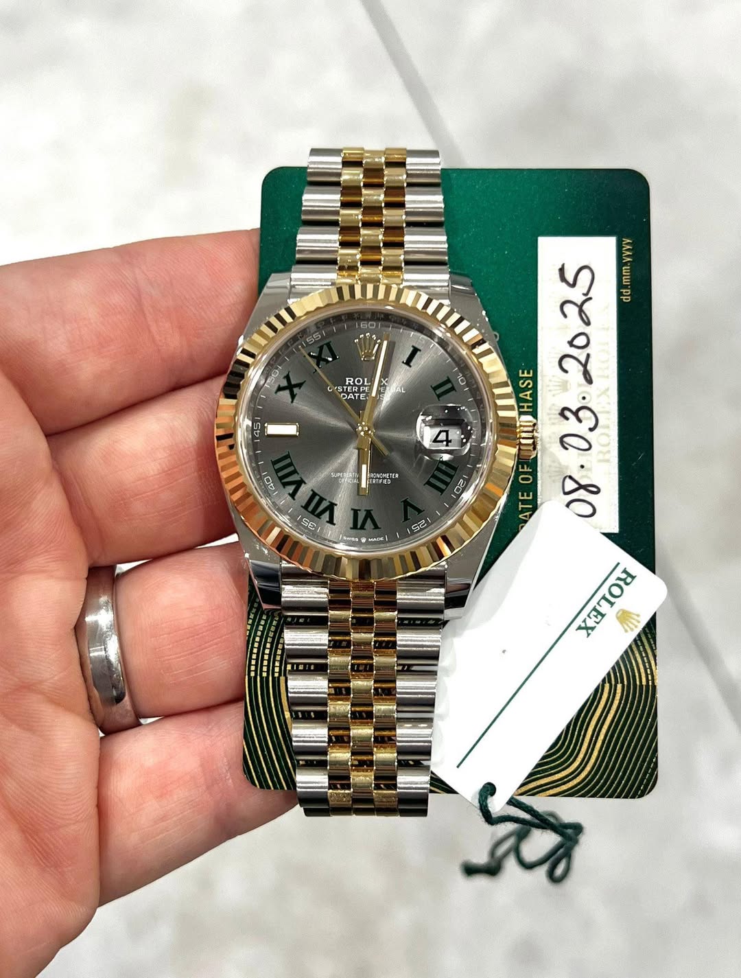May be an image of wrist watch and text