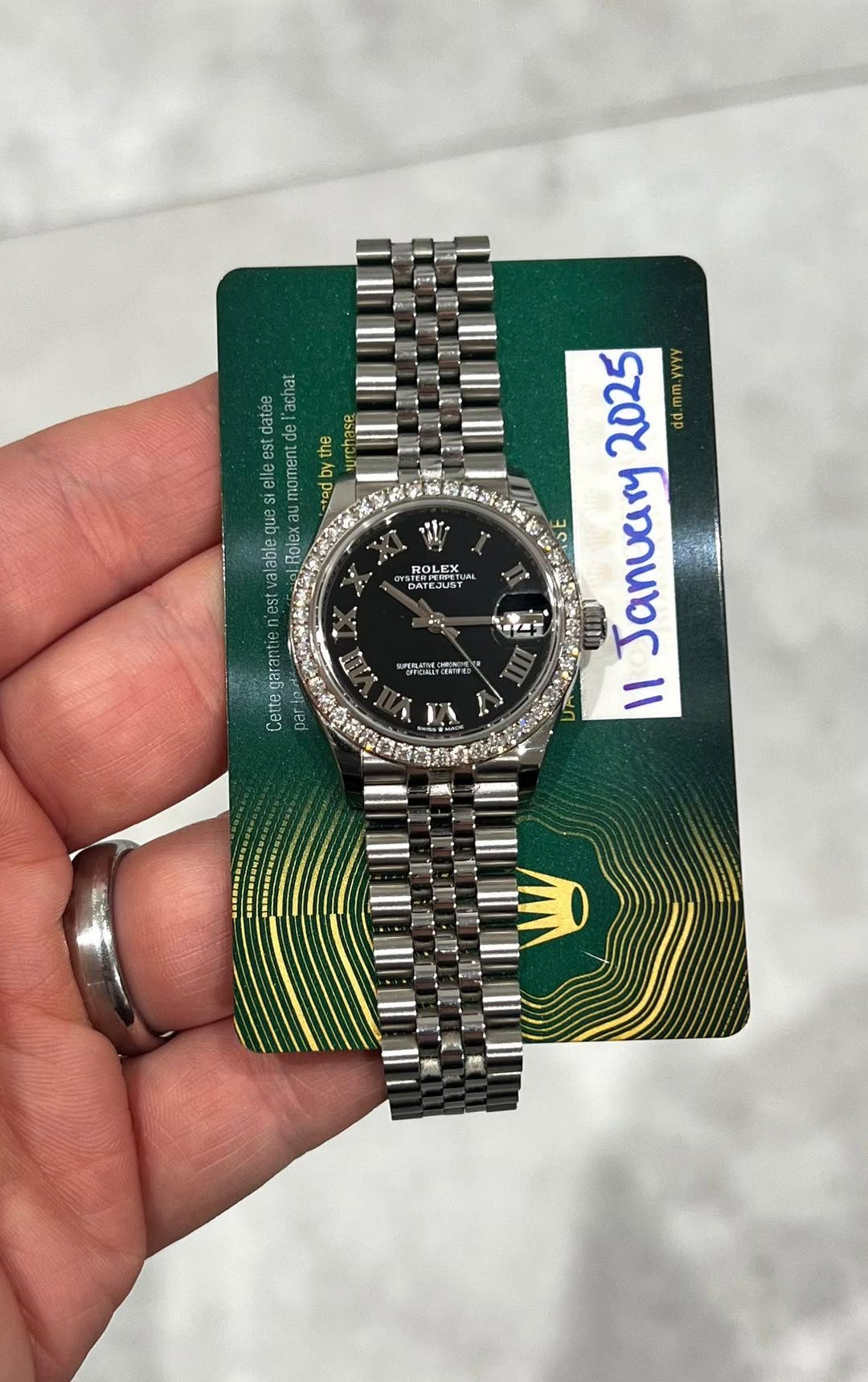 May be an image of wrist watch and text