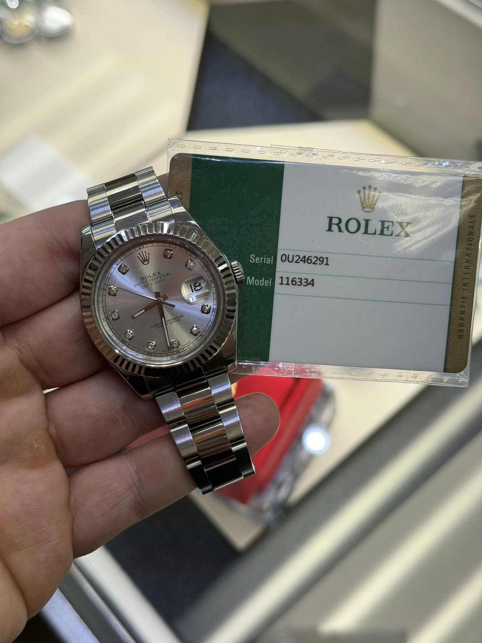 May be an image of wrist watch and text that says 'ब ROLEX Serial 0U246291 Model116334 Model 116334'