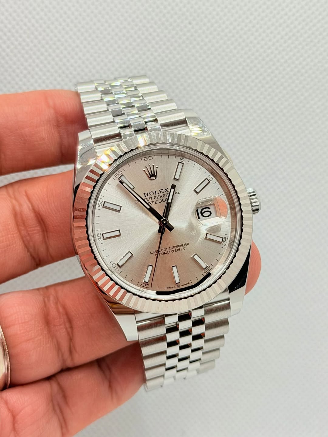 May be an image of wrist watch and text