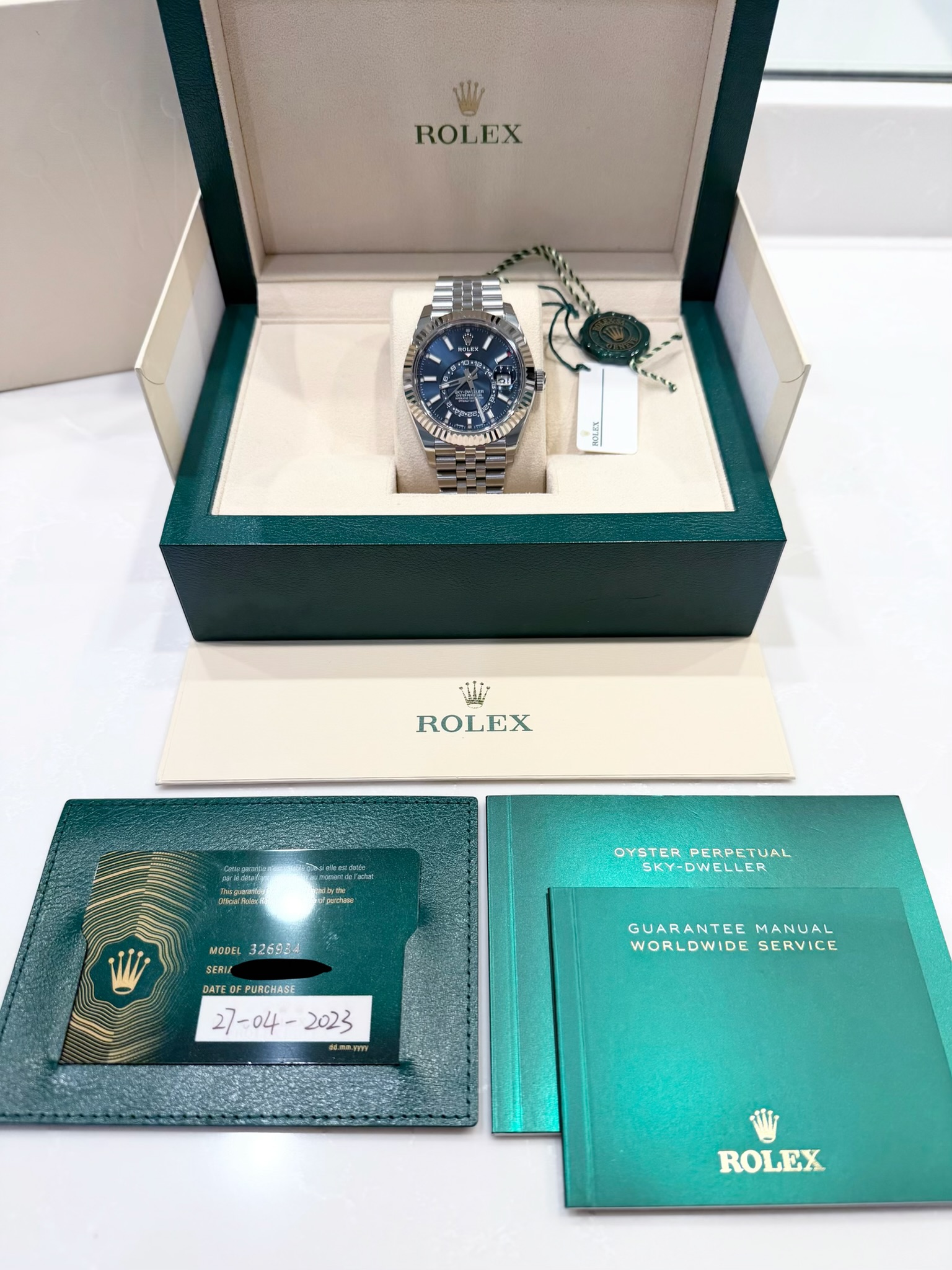 May be an image of wrist watch and text that says 'ROLEX อน กูิพนบ อ FROLES ROLEX PR purctuare OYSTER OYSTERPERPETUAL SKY-DWELLER SKY-DWELLER PERPETUAL MODEL 326934 SERI…