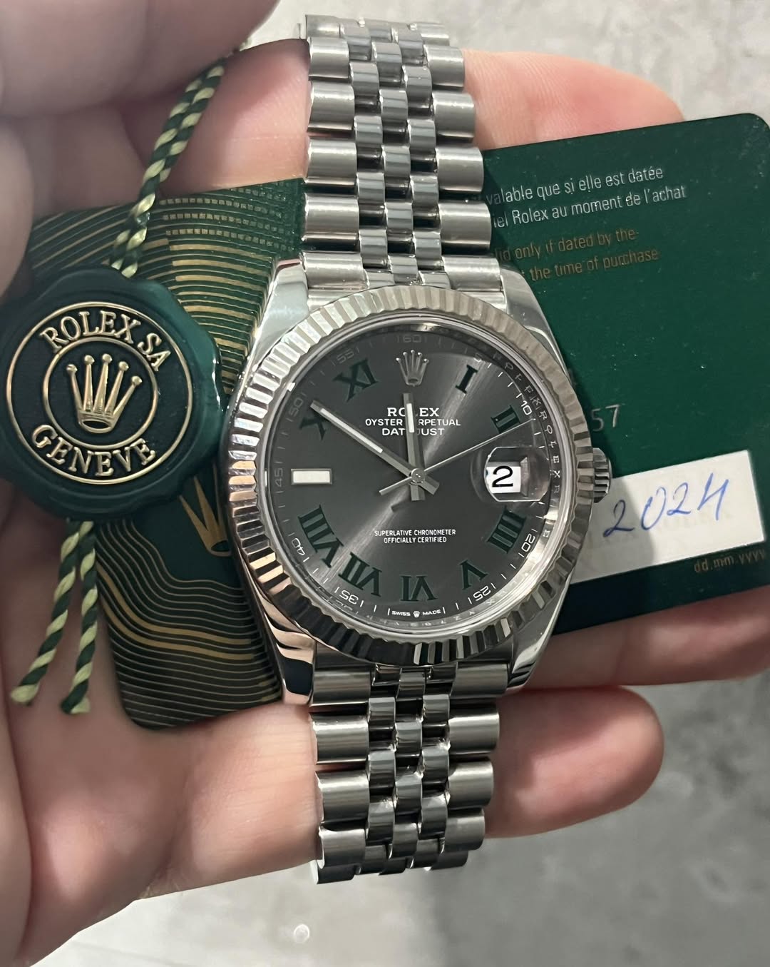 May be an image of wrist watch and text