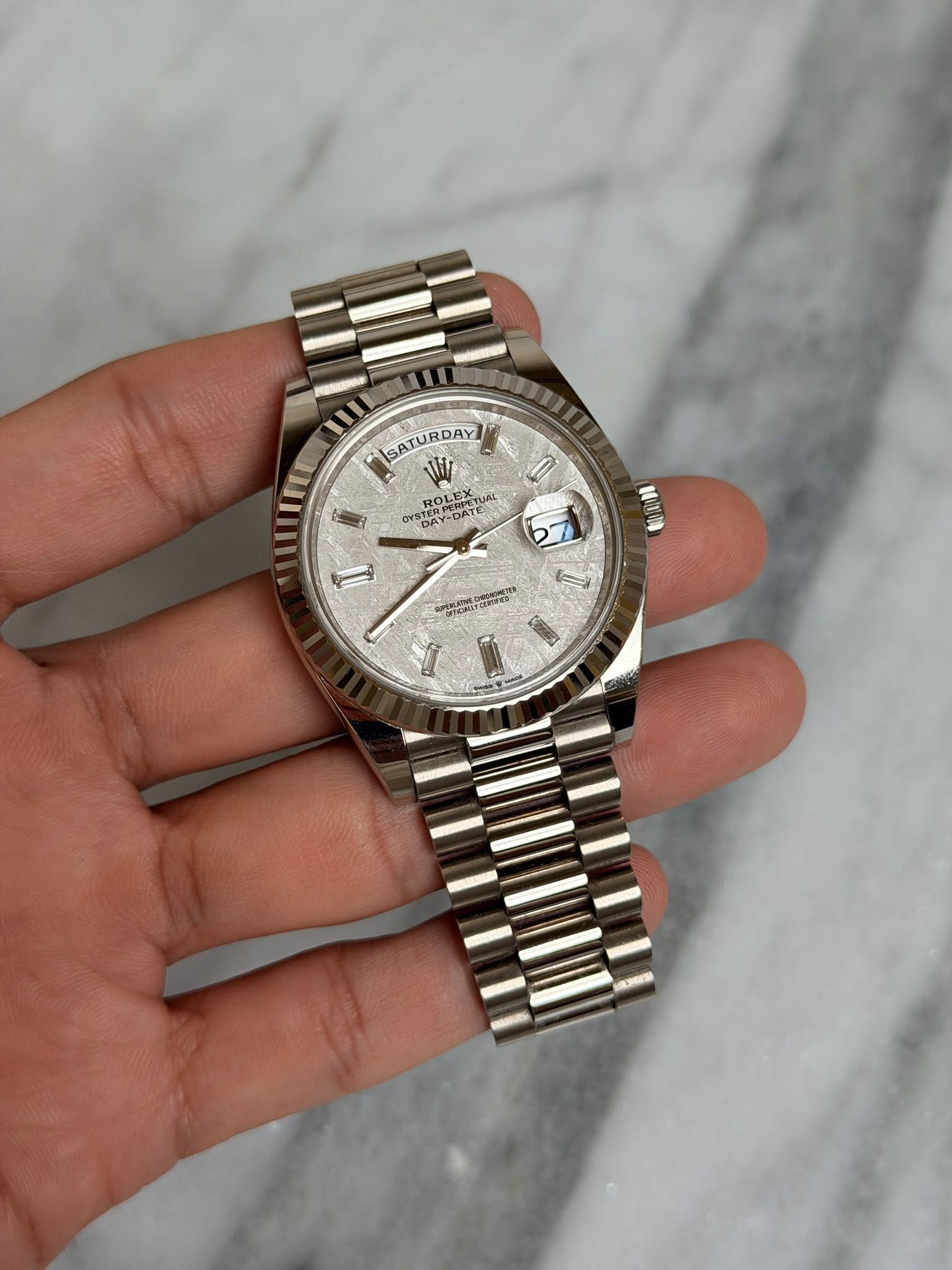May be an image of wrist watch and text