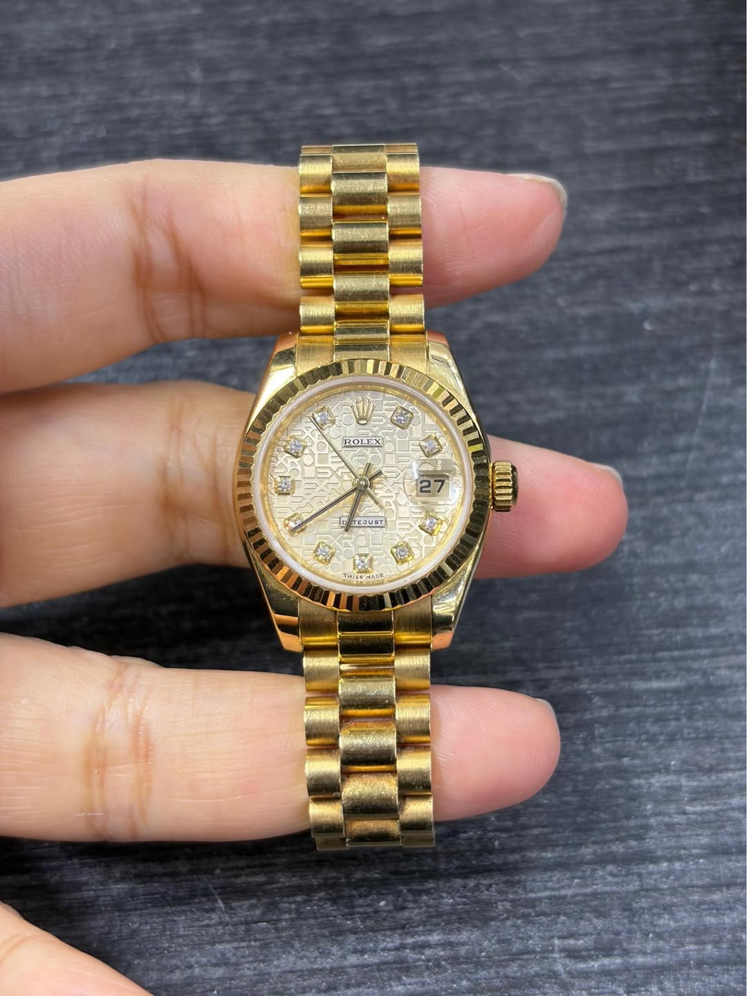 May be an image of wrist watch and text