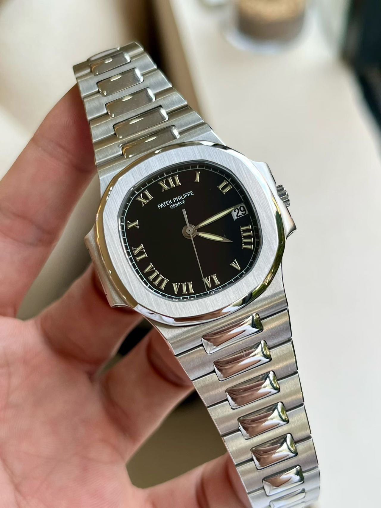 May be an image of wrist watch and text that says 'KIII Y XI PHILIPPE PATEK GENEVE GENEVE EVE CNE U I 1 IX 2 IIII TILI V л A VI'