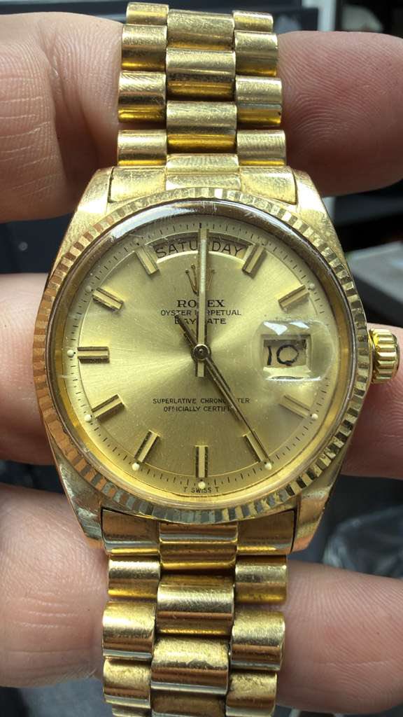 May be an image of wrist watch and text