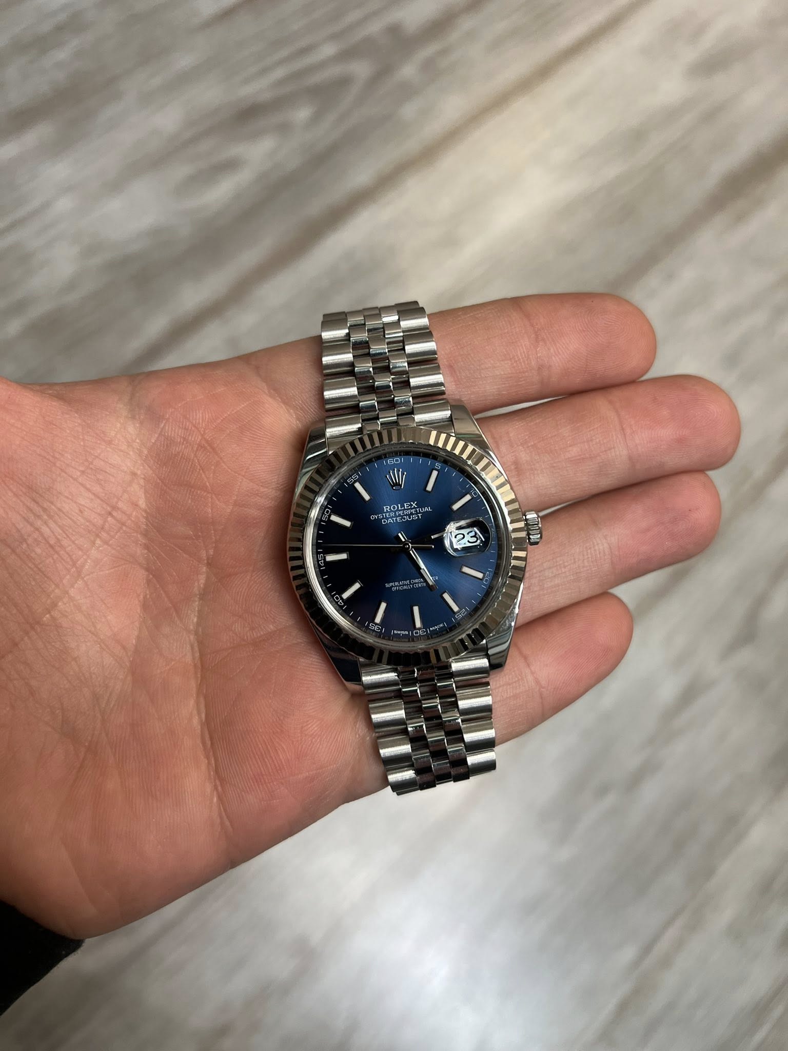 May be an image of wrist watch and text that says 'HOLECX 23'