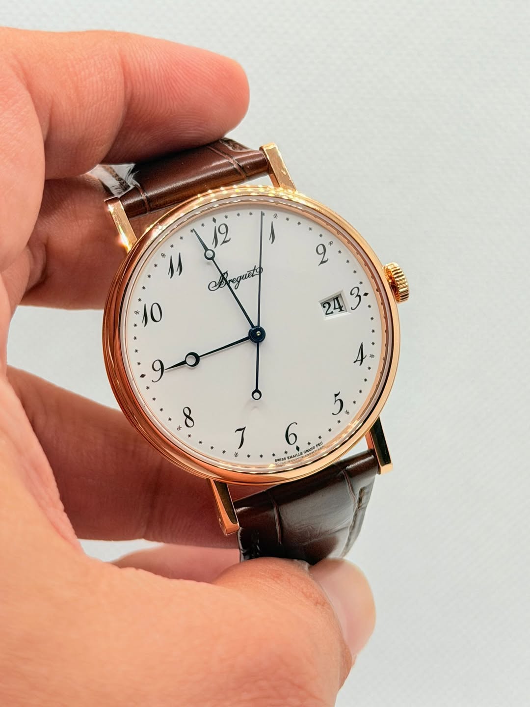 May be an image of leather, wrist watch and text