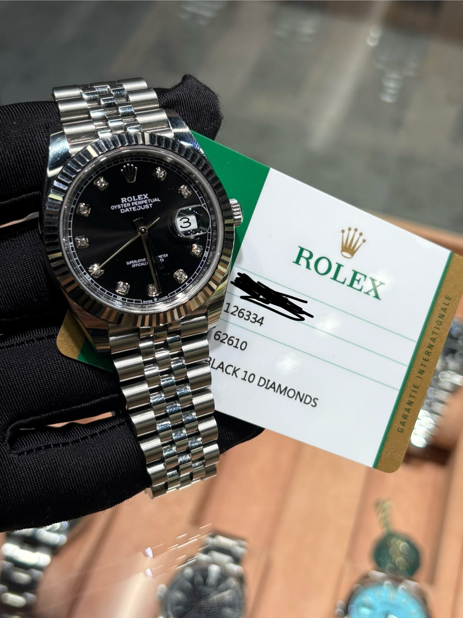 May be an image of wrist watch and text that says 'ROLEX PERPETU RPERI ERPERIA ROLE YST STERP DATE DATEJUST JUST 3 سععت aIIm ROLEX BLACK 10 DIAMONDS'