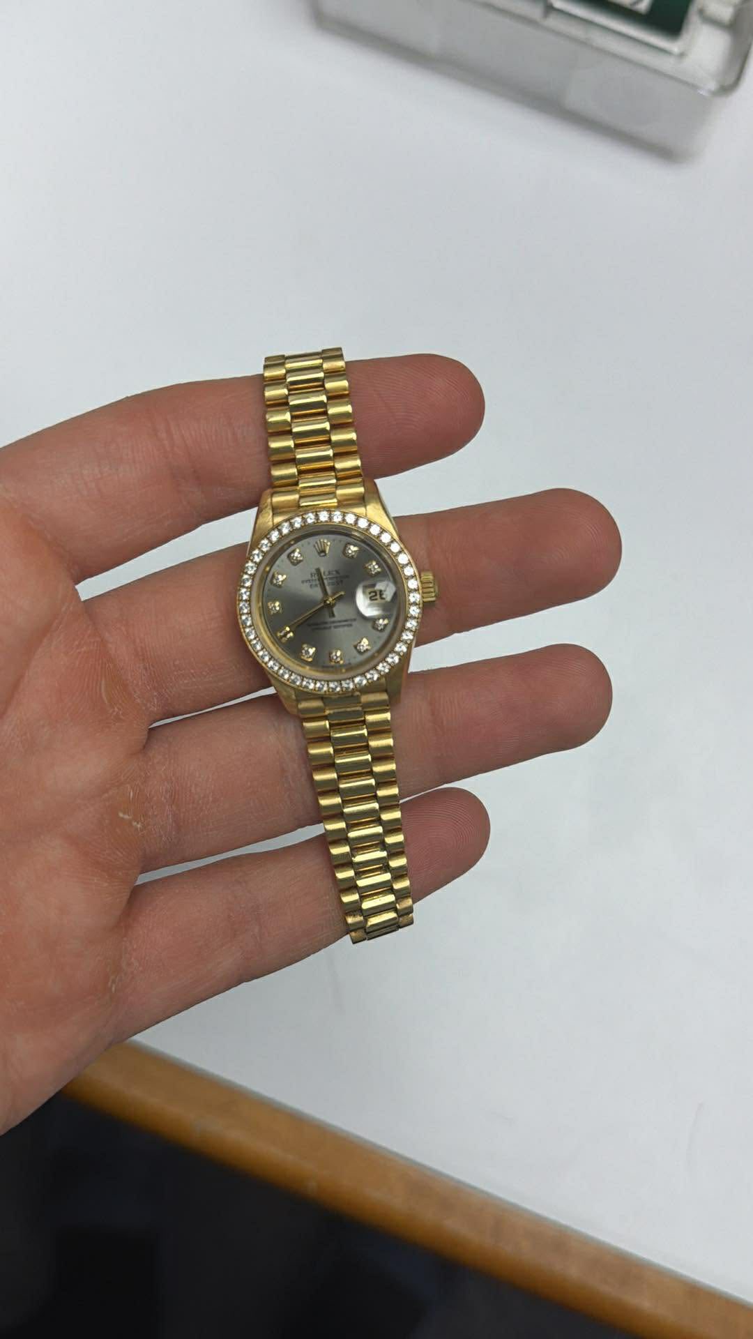 May be an image of wrist watch and text