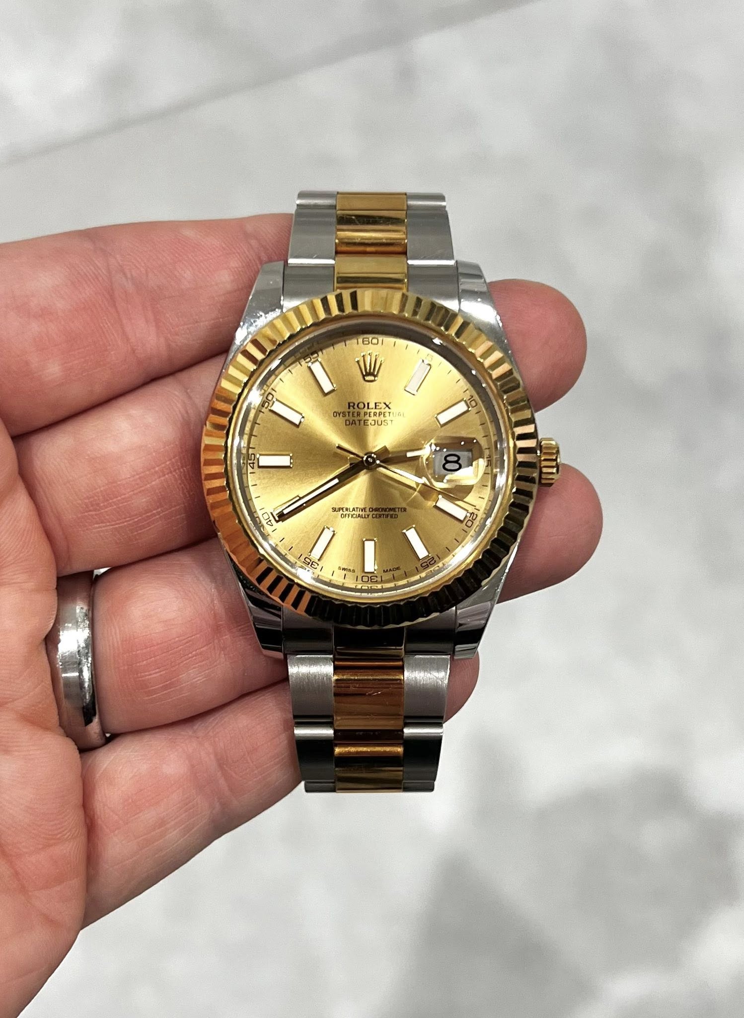 May be an image of wrist watch and text