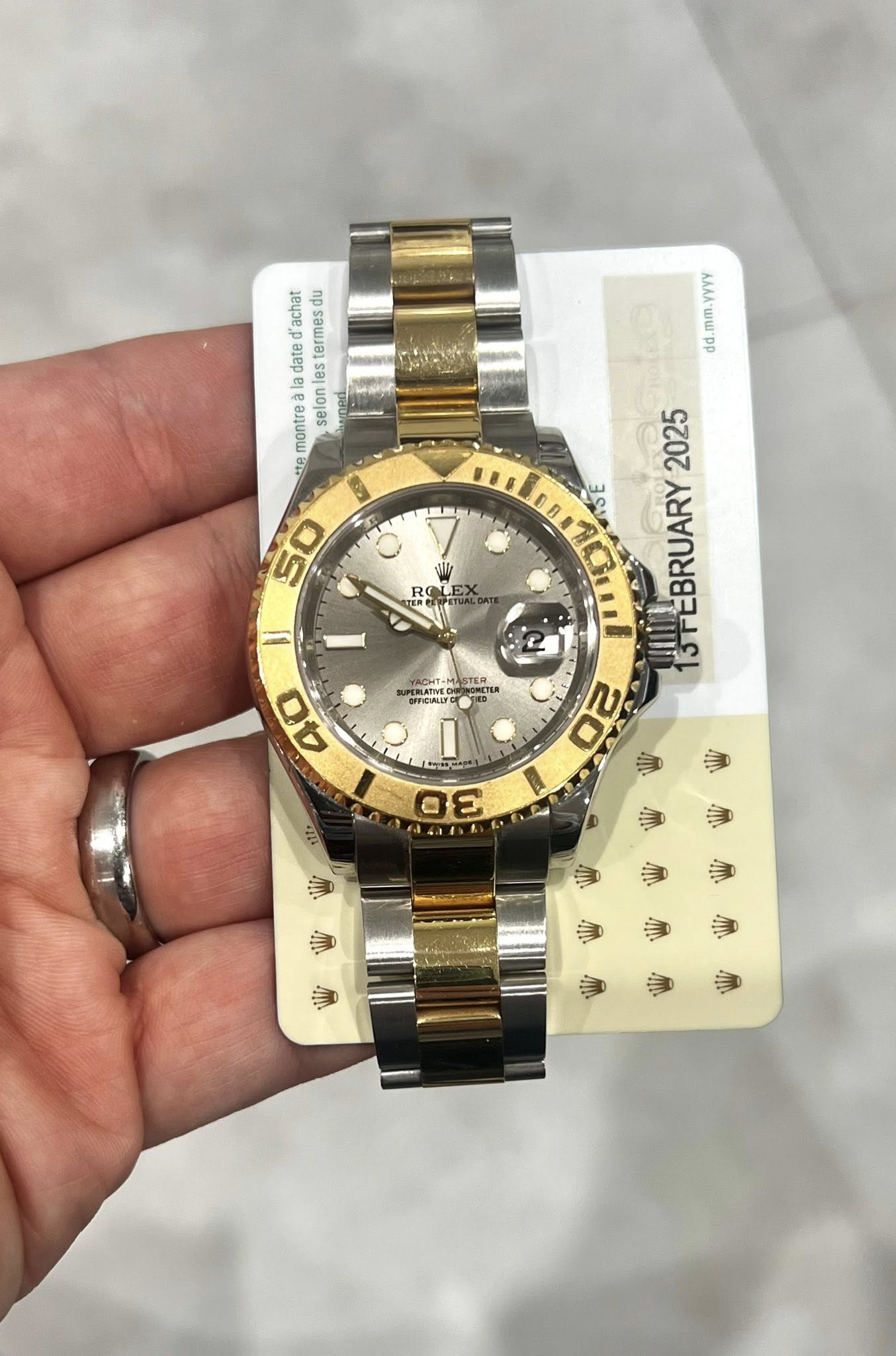 May be an image of wrist watch and text that says 'YYY mm.yYYY dd achat montrealadatedachat du termeso date ada les la montre selon 세유 50 EX RO 付克所 YACHTN LRALIES STER 2025 3S…