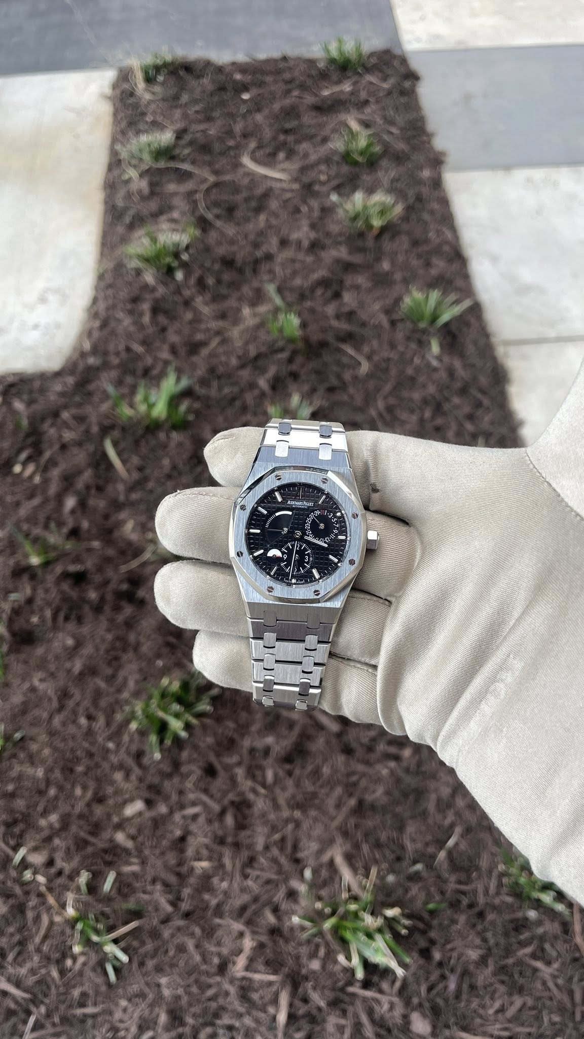 May be an image of wrist watch, grass and text