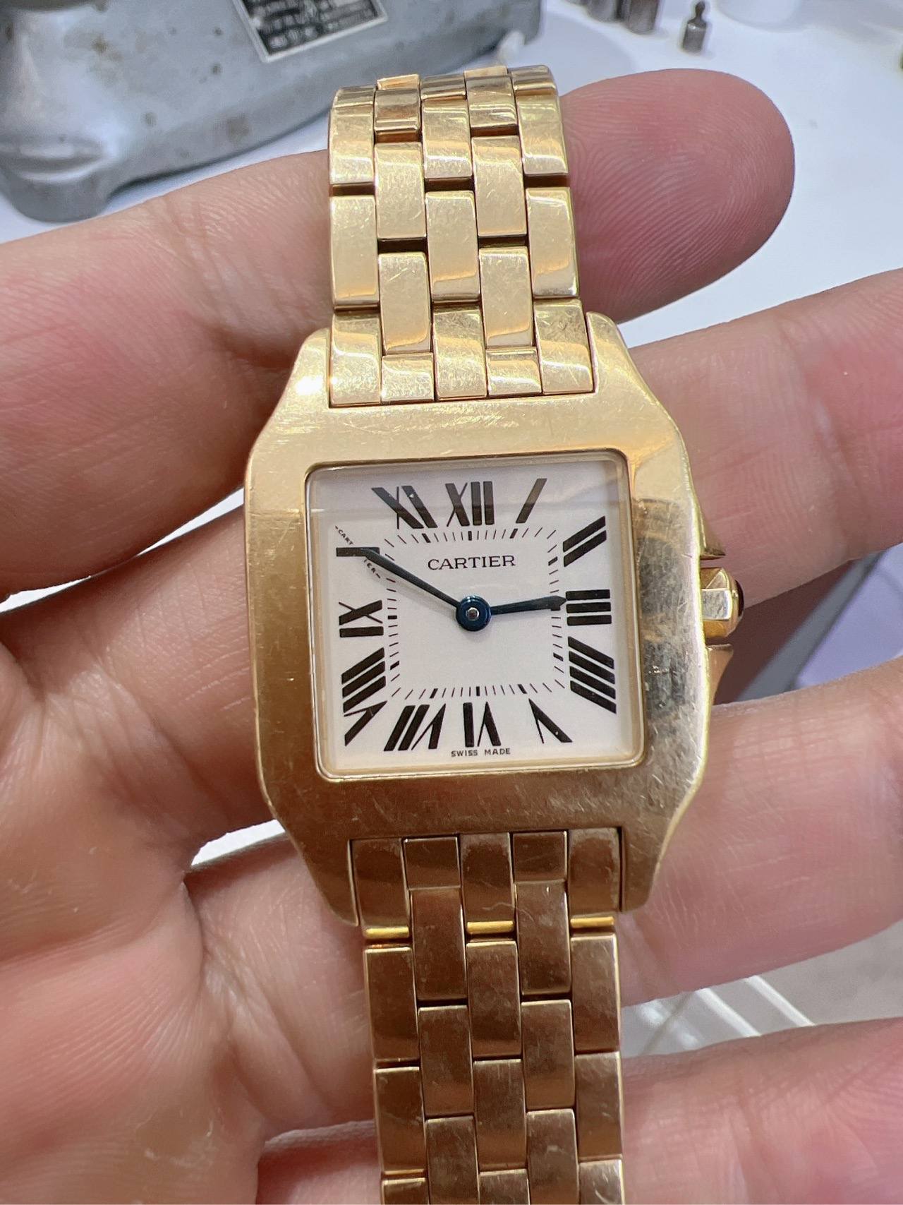 May be an image of wrist watch and text