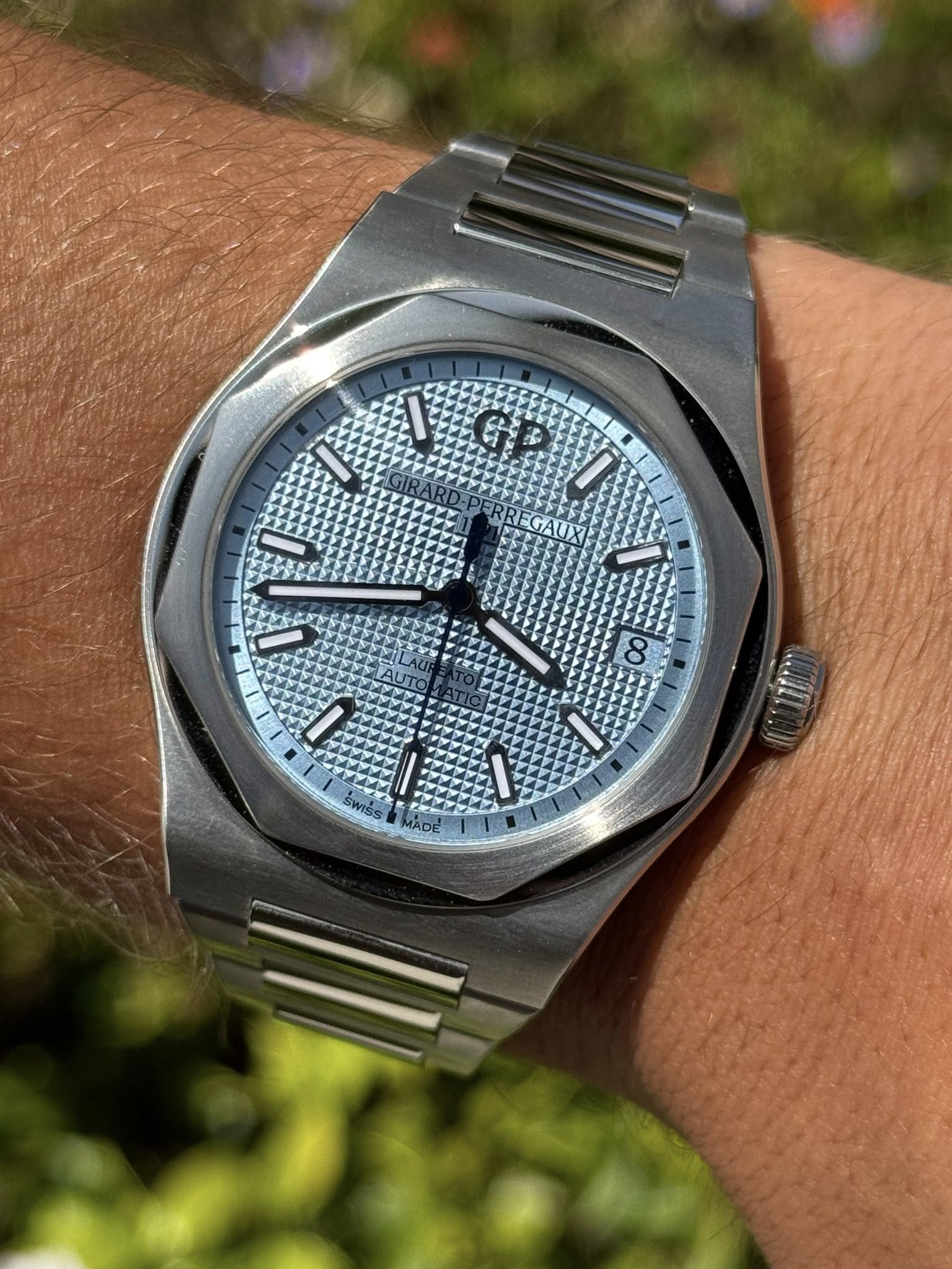 May be an image of wrist watch and text