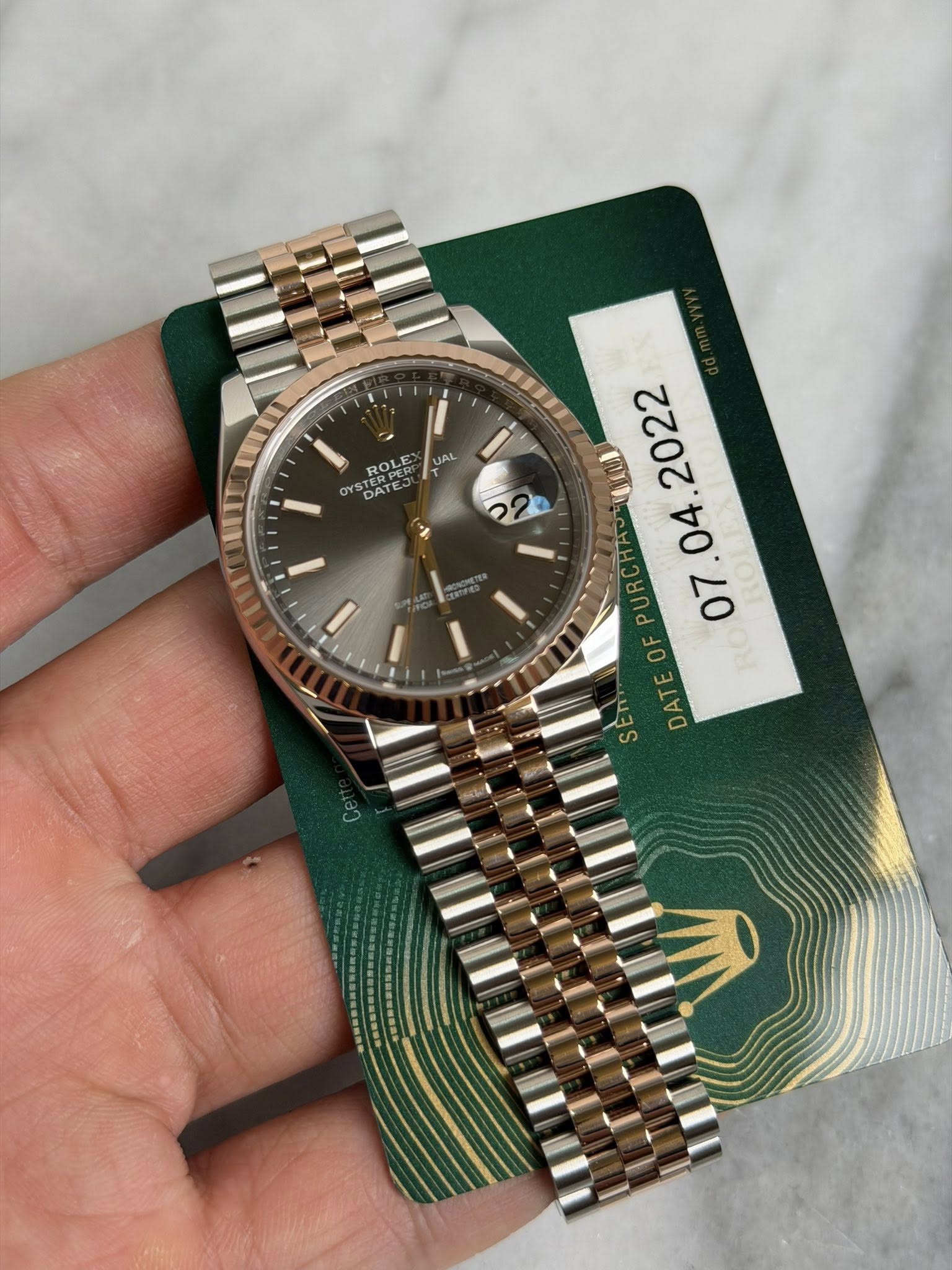 May be an image of wrist watch and text