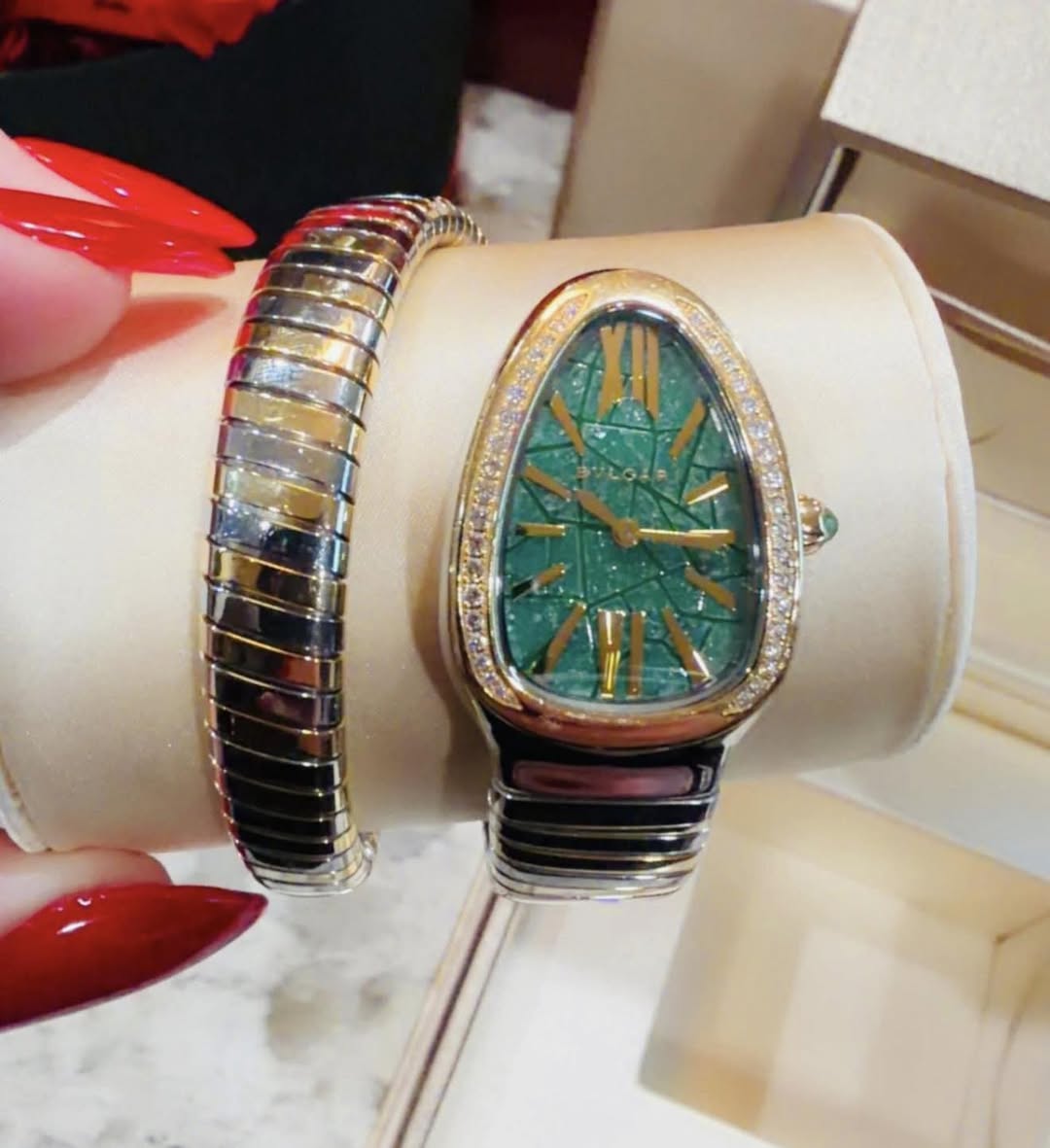 May be an image of wrist watch and jewelry