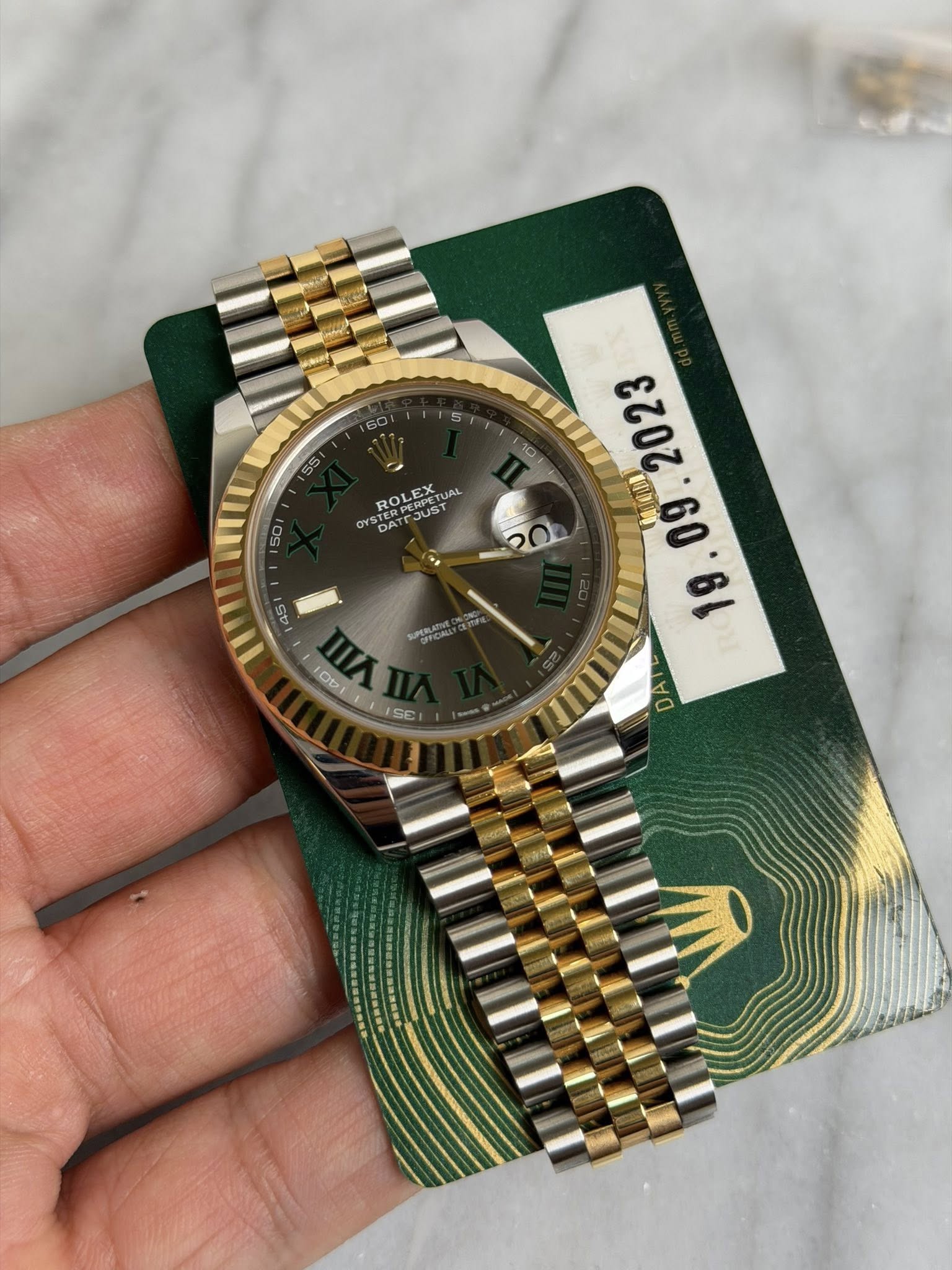 May be an image of wrist watch and text that says 'A # M o h N'