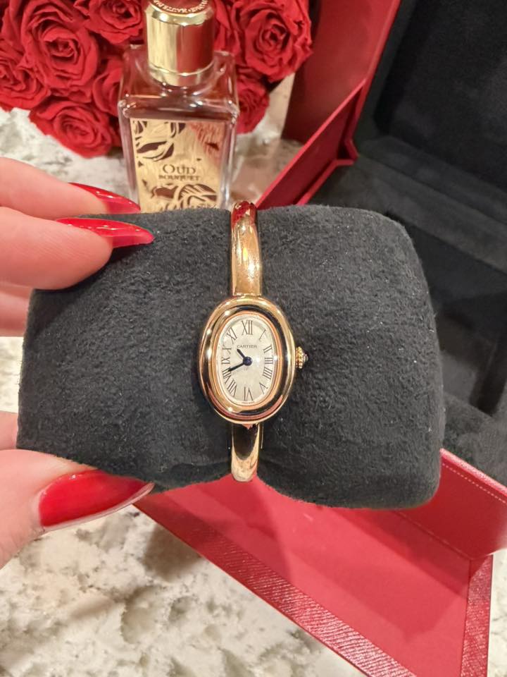 May be an image of fragrance, wrist watch and text