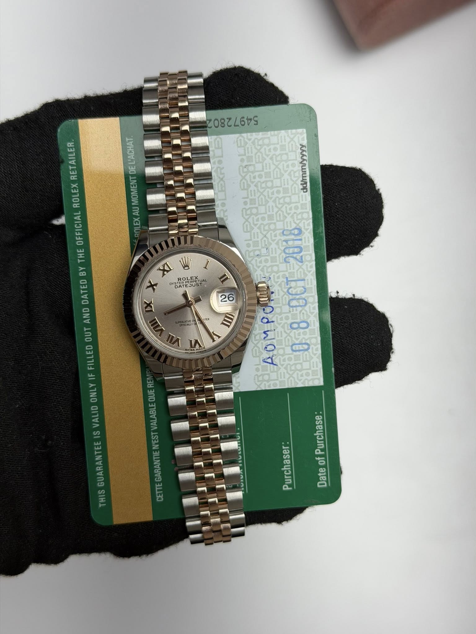 May be an image of wrist watch and text that says 'S0824475 L'ACHAT DE AU EX dd/mmyyyy RETAILER ROLEX OFFICIAL THE B DATED AND OUT FILLEDO VALIDONLY1F XI DATEJU ١٨ 2018 26 II…