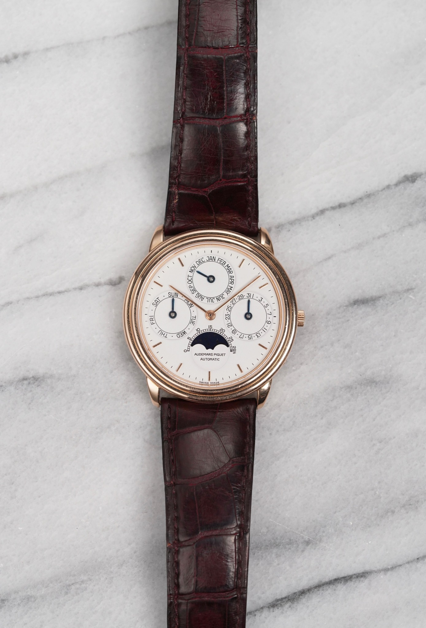 May be an image of leather, wrist watch and text