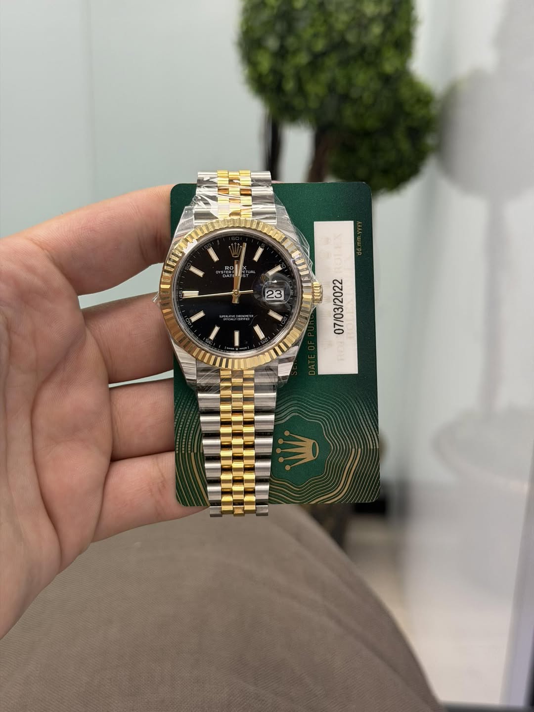 May be an image of wrist watch and text