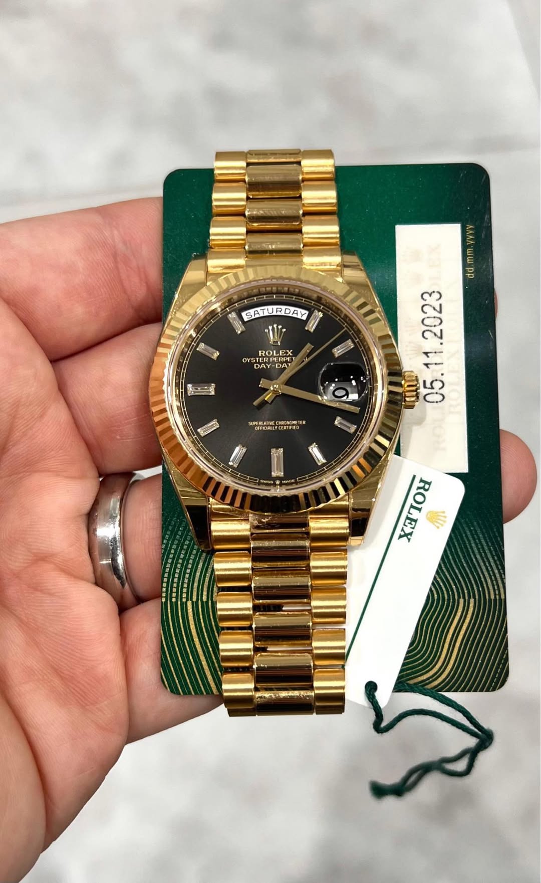 May be an image of wrist watch and text