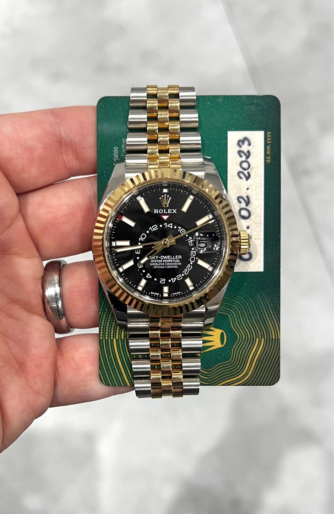 May be an image of wrist watch and text