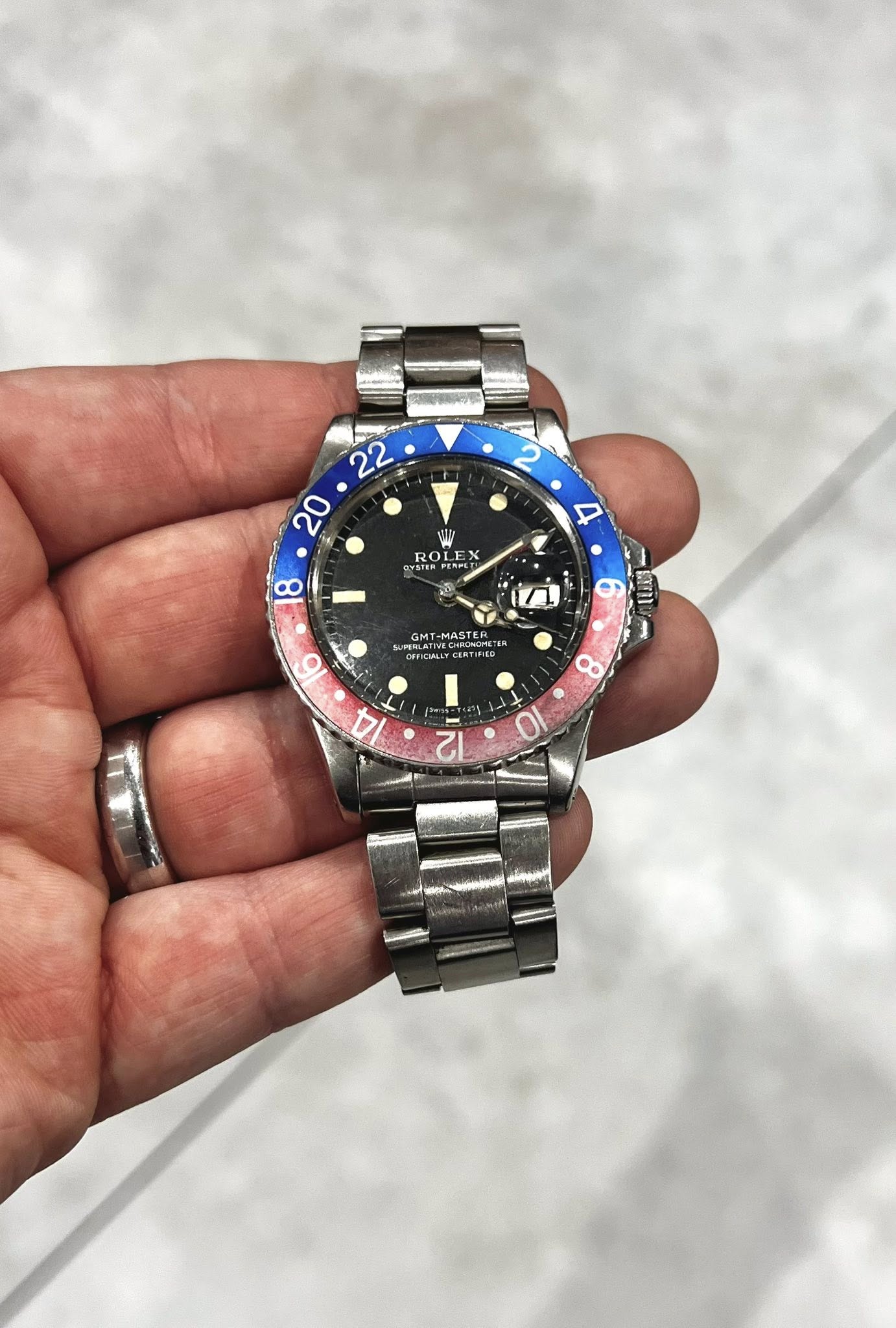 May be an image of wrist watch and text