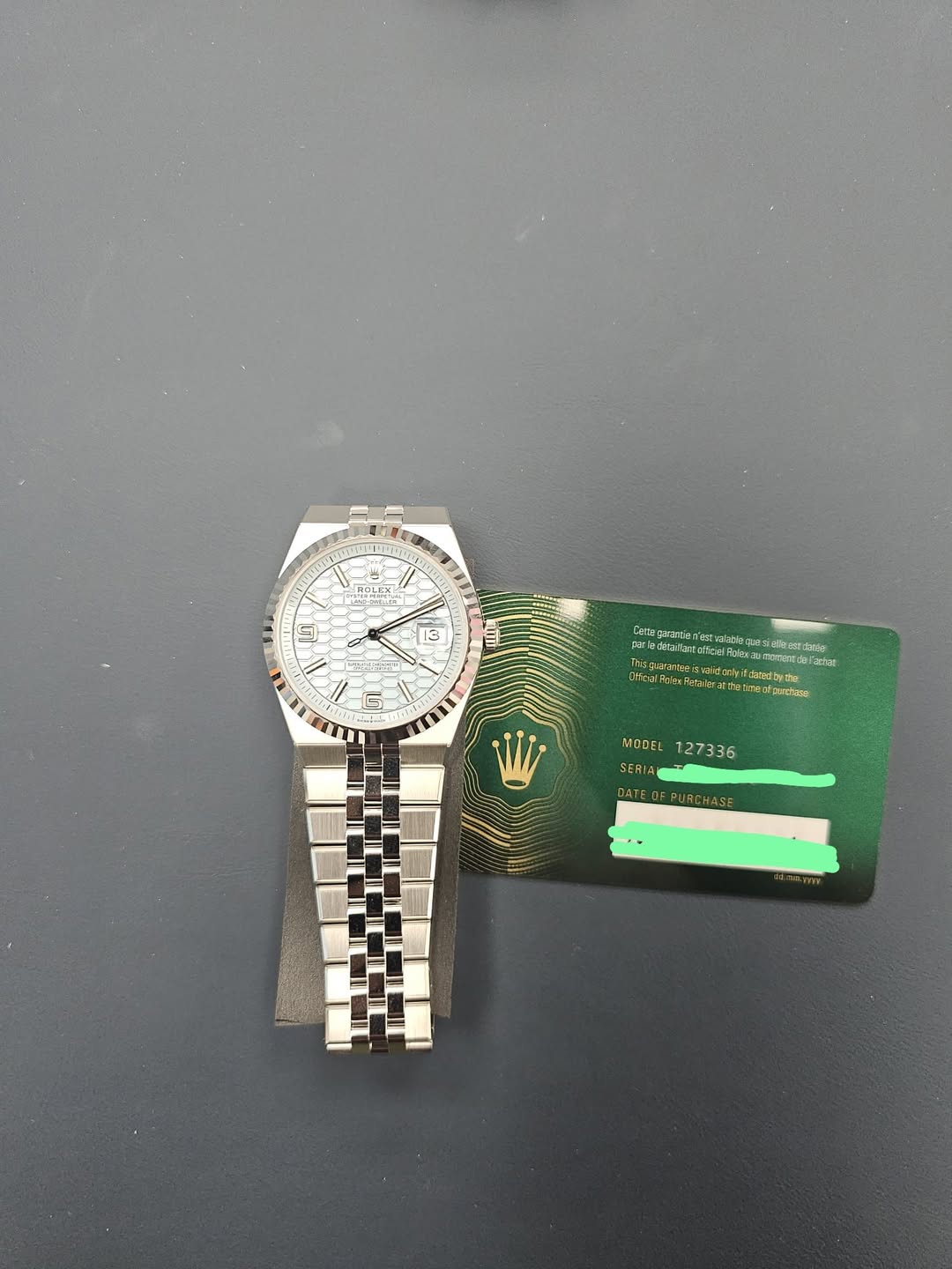 May be an image of money, wrist watch and text