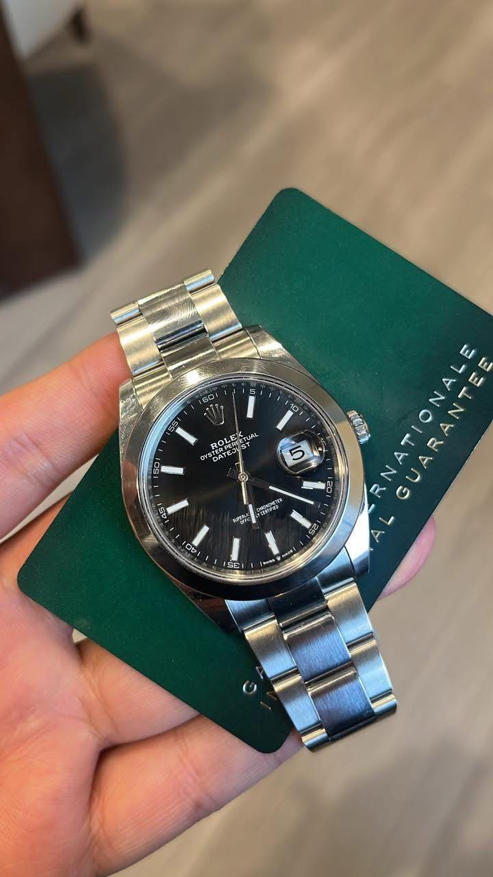 May be an image of wrist watch and text