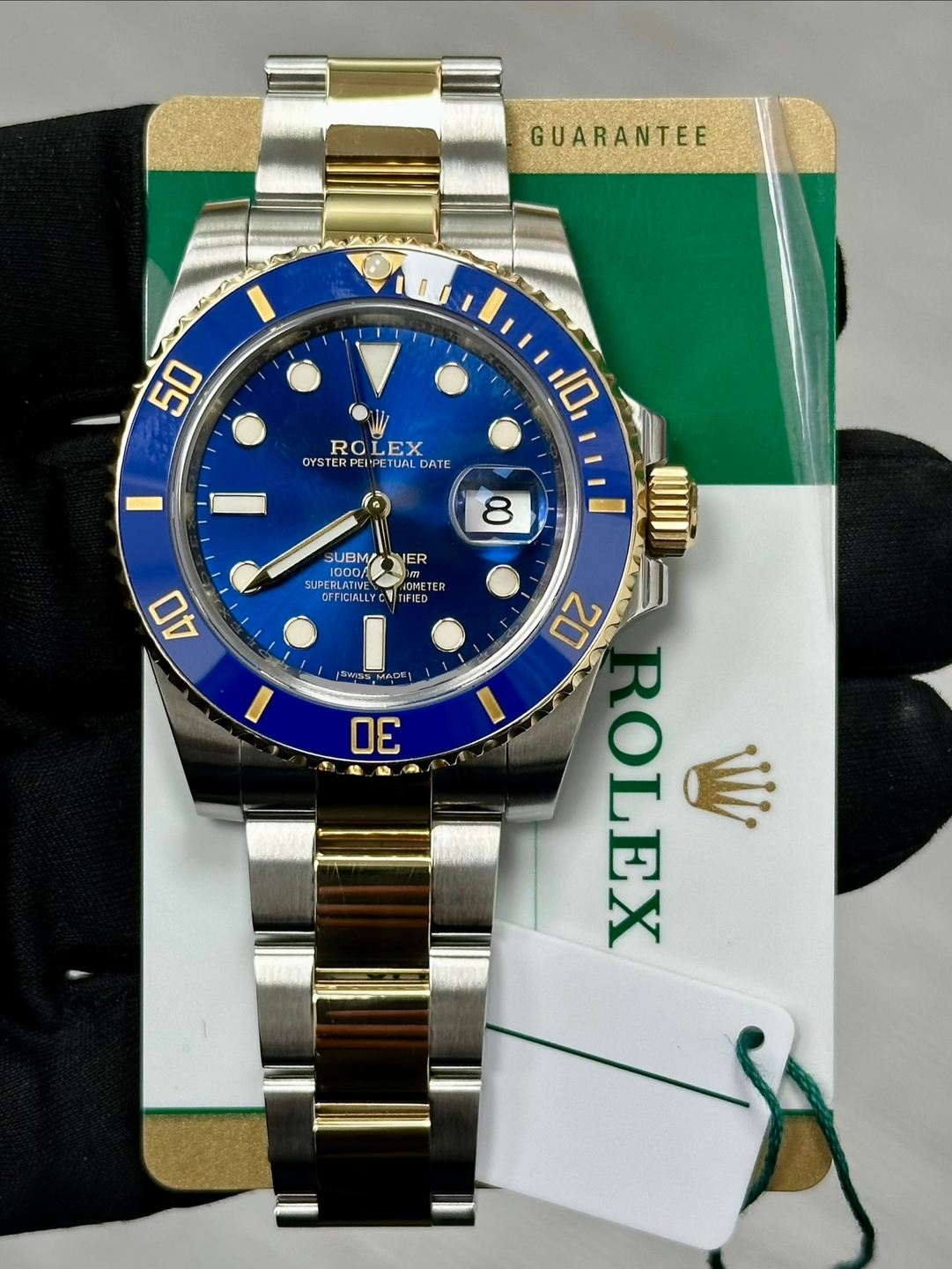 May be an image of wrist watch and text that says 'GUARANTEE 50 ROLEX EX RO OYSTERPEIPETUALDATE OYSTE YSTERPER UAL YSTERPEIPETUALDA UAL DATE 10 8 UBM ស្ SUBM ER SUPER UPERLATN…