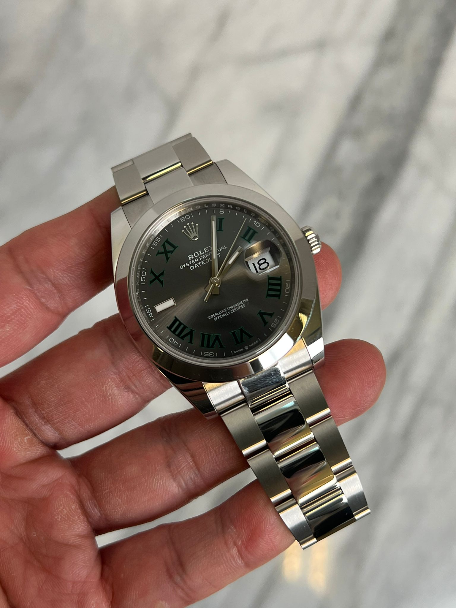 May be an image of wrist watch and text