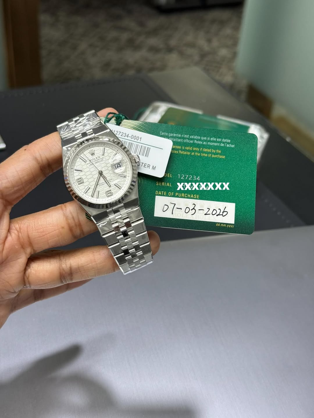 May be an image of wrist watch and text