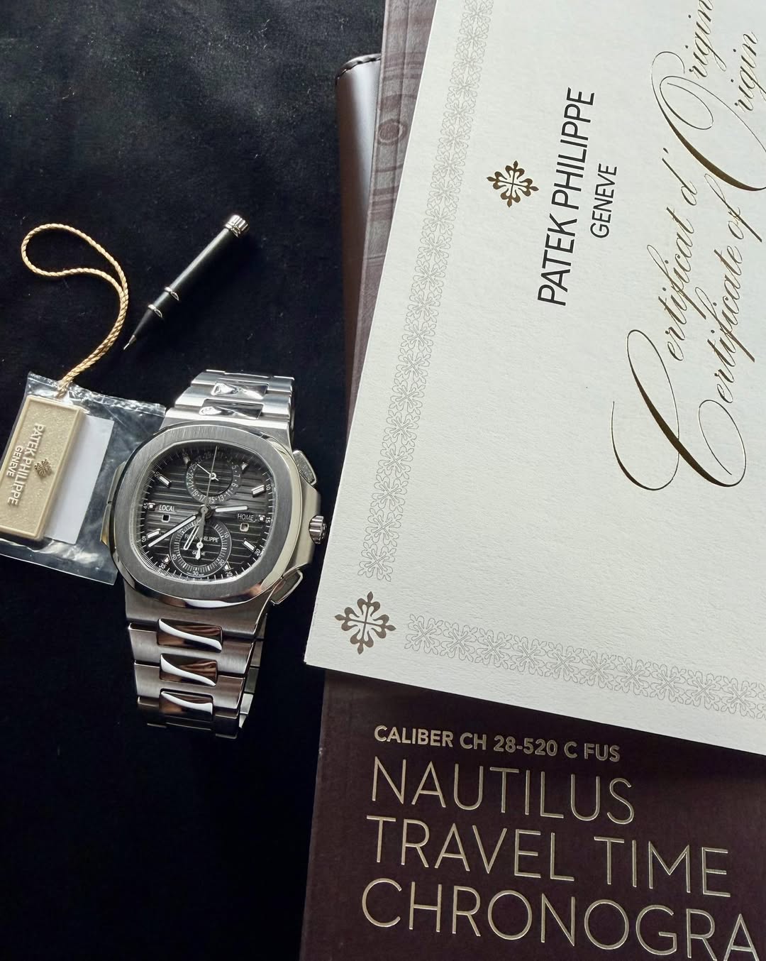 May be an image of wrist watch and text that says '楽 PHILIPPE GENEVE PATEK ی 크터 時起 add ር 塩 1 佐 P யர்ம் CALIBER NAUT NAUTILUS TRAVEL TIME TRAVELTIME T CHRONOGRA'